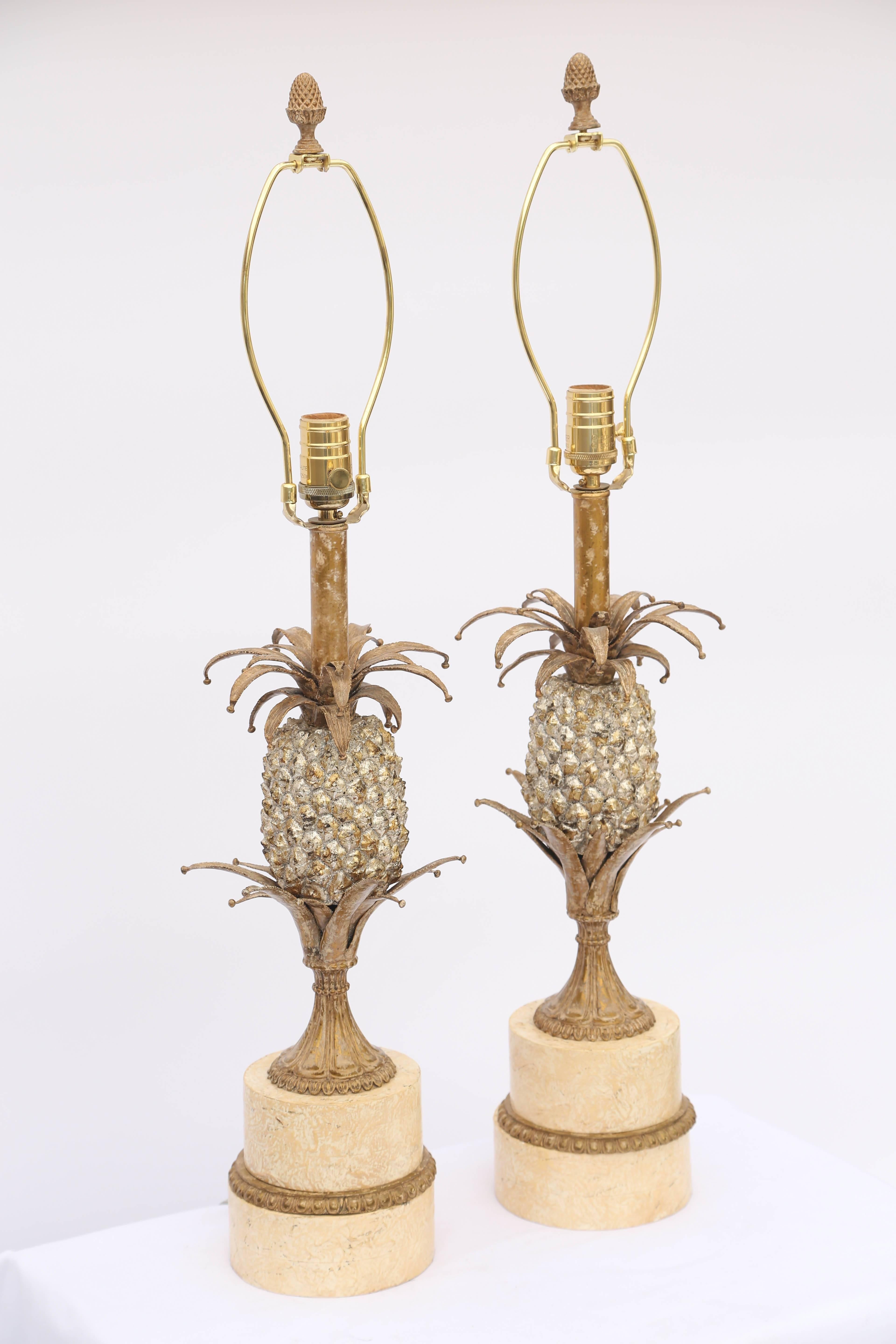 Pair of lamps, each fashioned as a pineapple, of metal with silver and gold gilt, set upon round, graduating plinth.

Stock ID: 7856.