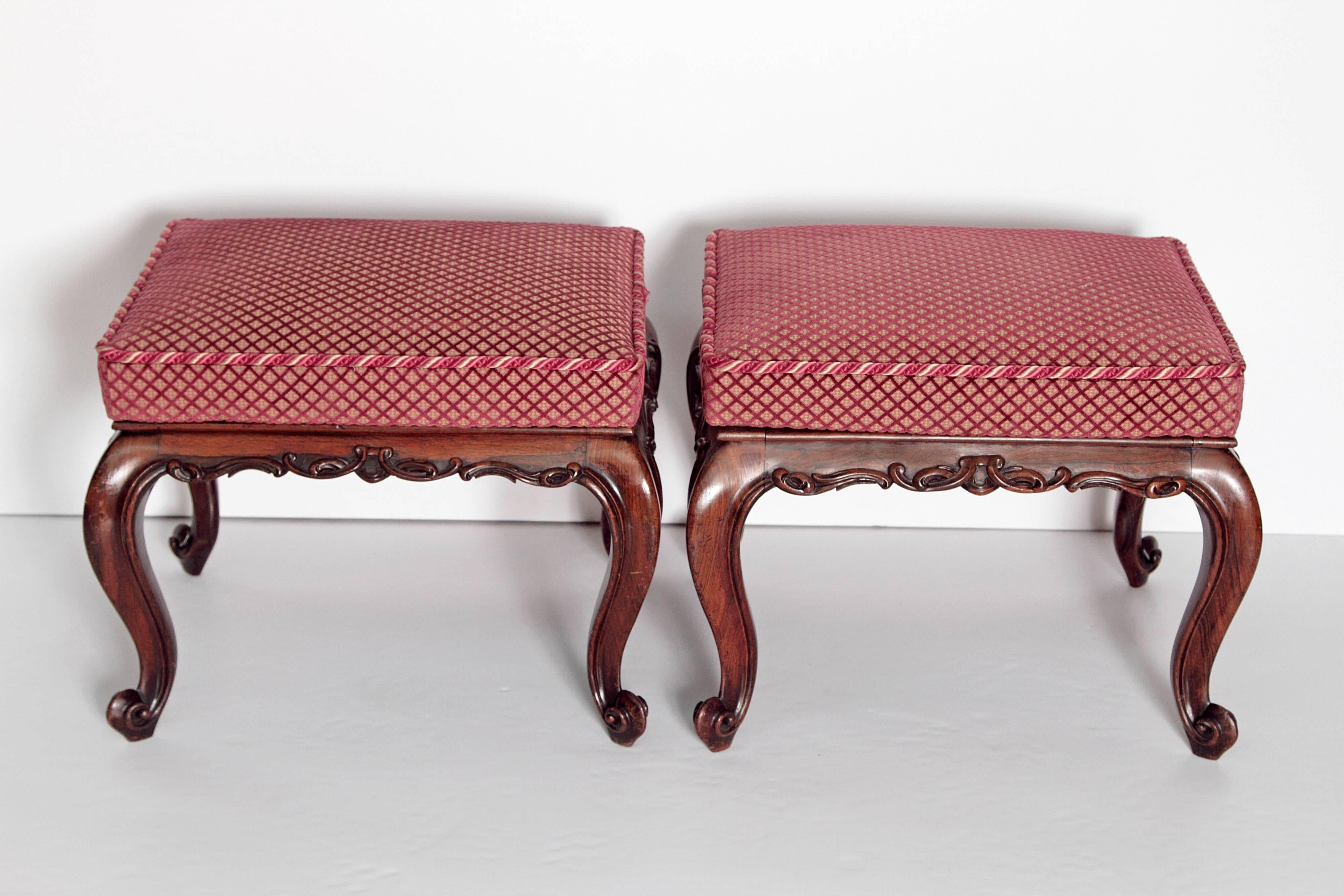 A pair of finely carved mid-Victorian rosewood stools in the Louis XV style with upholstered drop in seats.