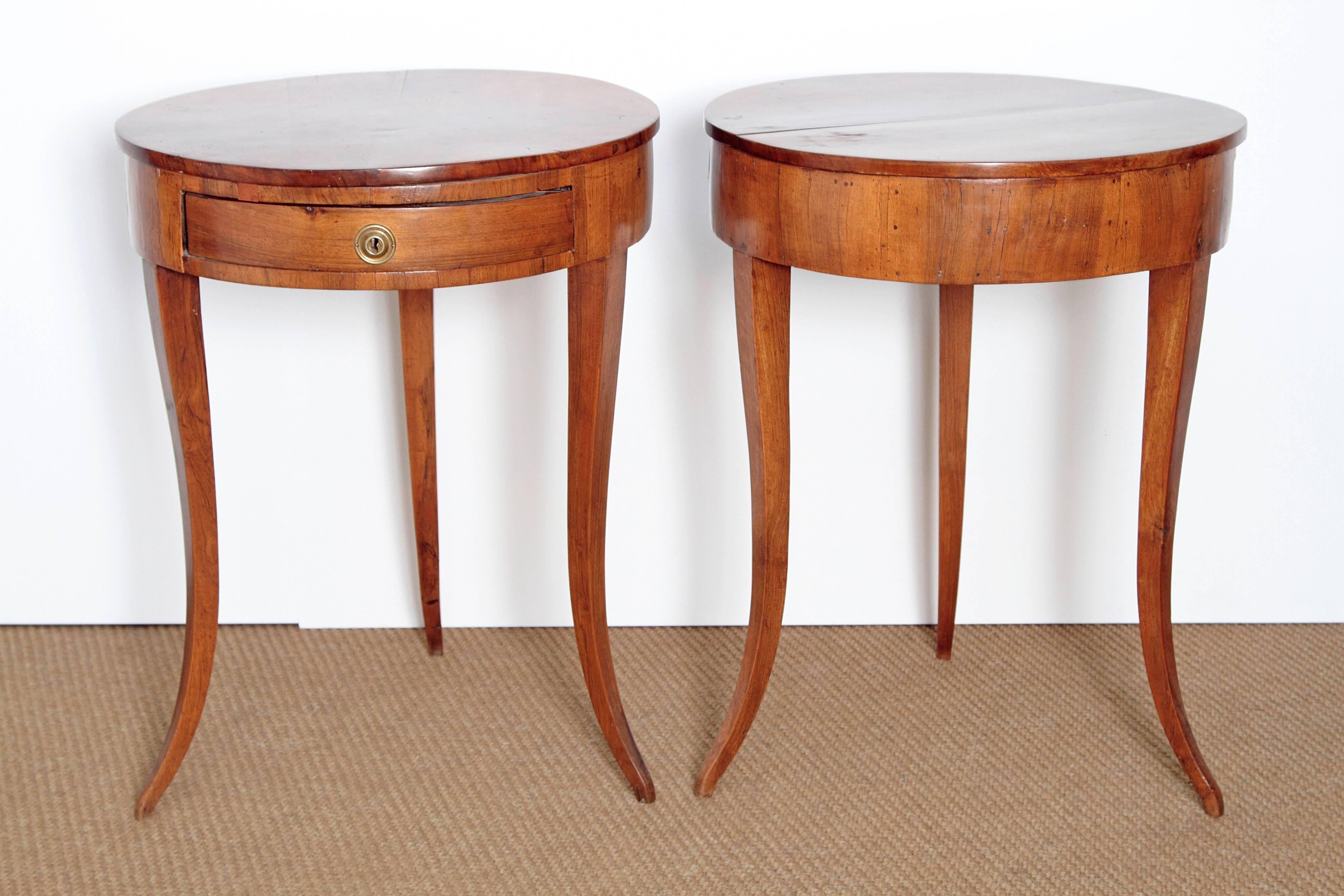 Early 19th century, pair of small Continental side tables or gueridons, neoclassical, possibly German, each has a single drawer and each has three (3) slender saber legs.