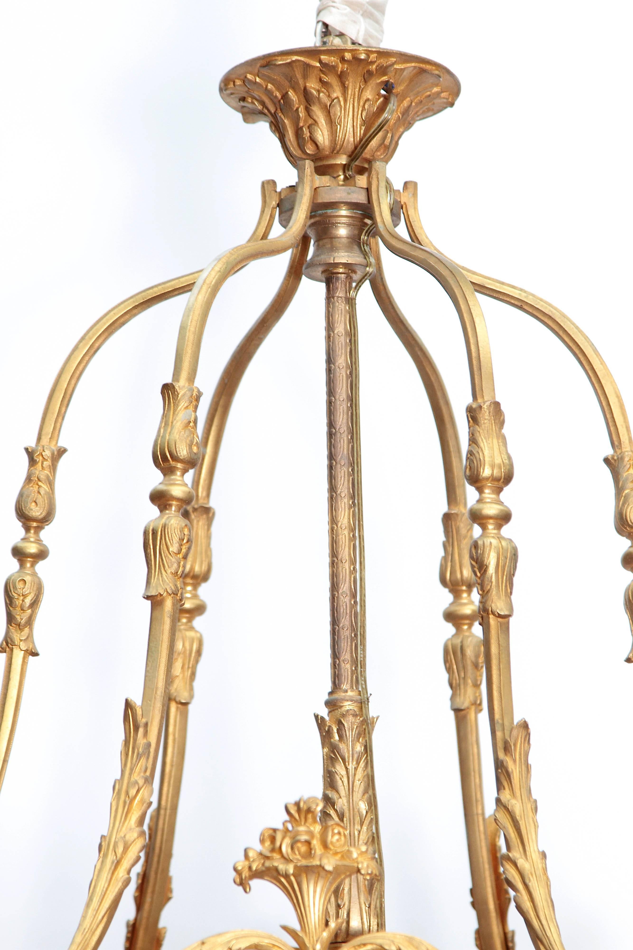 A large Louis XVI style six-light gilded bronze lantern, originally fitted for gas. Exceptional chaste castings and fine mercury gilding, the lantern composed of gentle S-curved upper and lower section supports with acanthus leaf scrolls. The body
