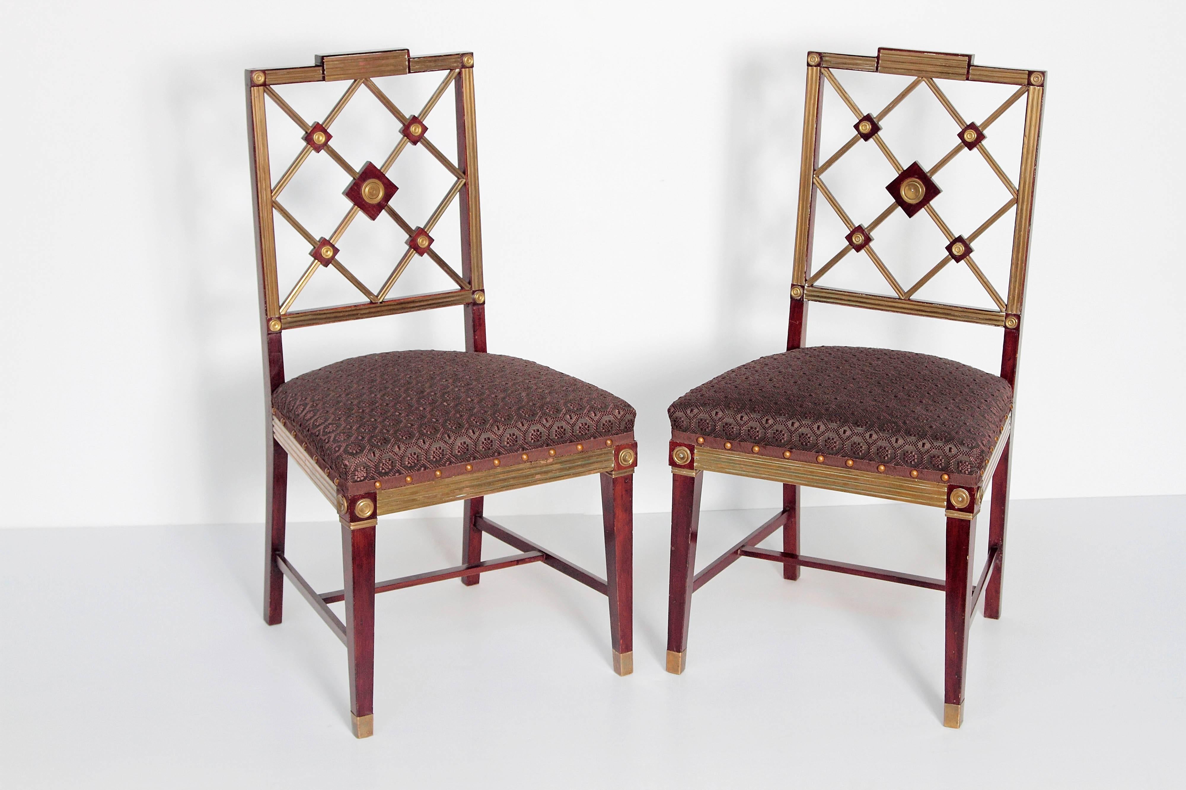 A pair of Russian Empire neoclassical side chairs, mahogany with fluted brass mouldings and fittings, the backs of joined latticework design with tight seats in dark chocolate brown horsehair upholstery with spaced nail-heads and trim. Imperial