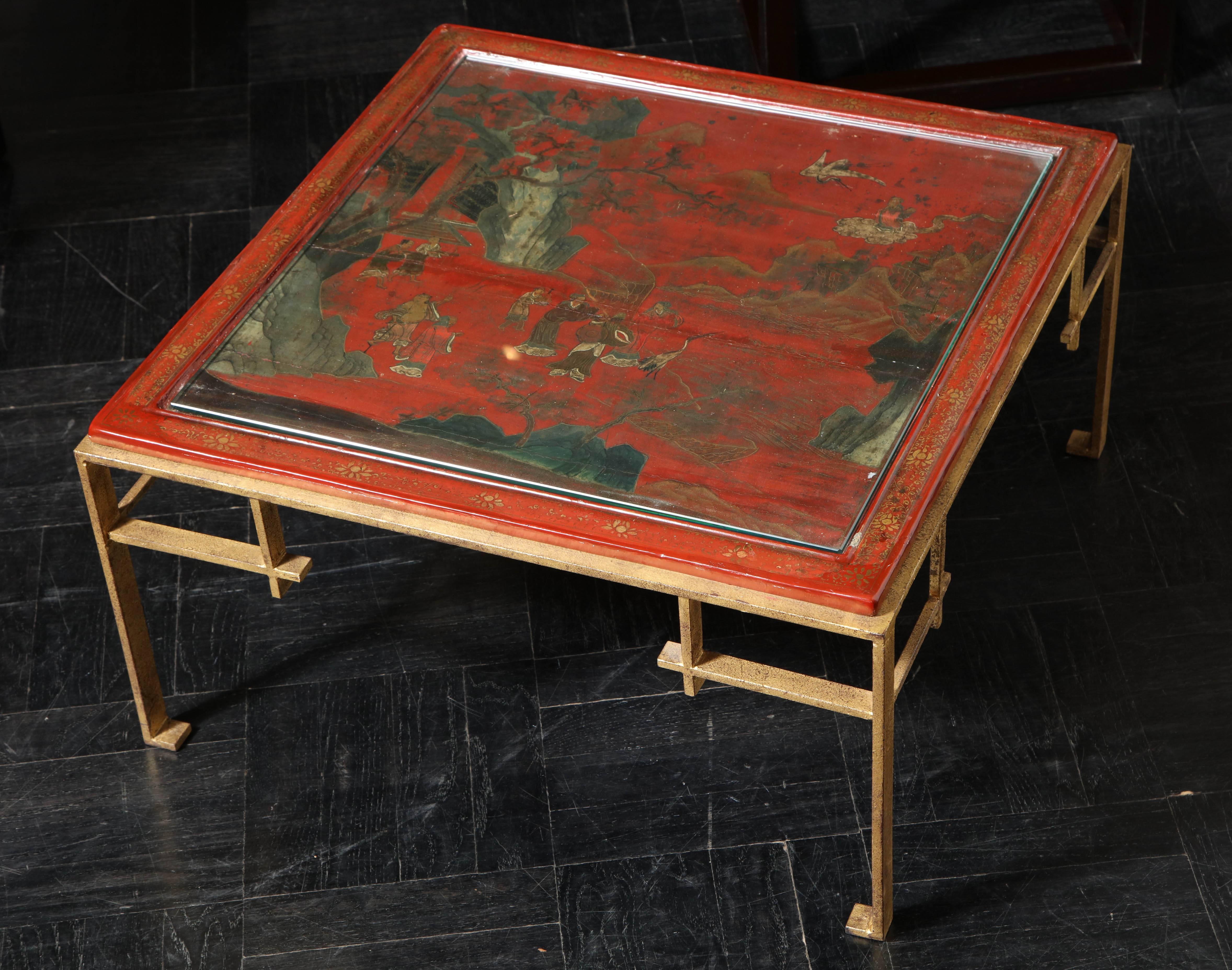 19th century cocktail table; red Coromandel top on later painted gilt iron base.