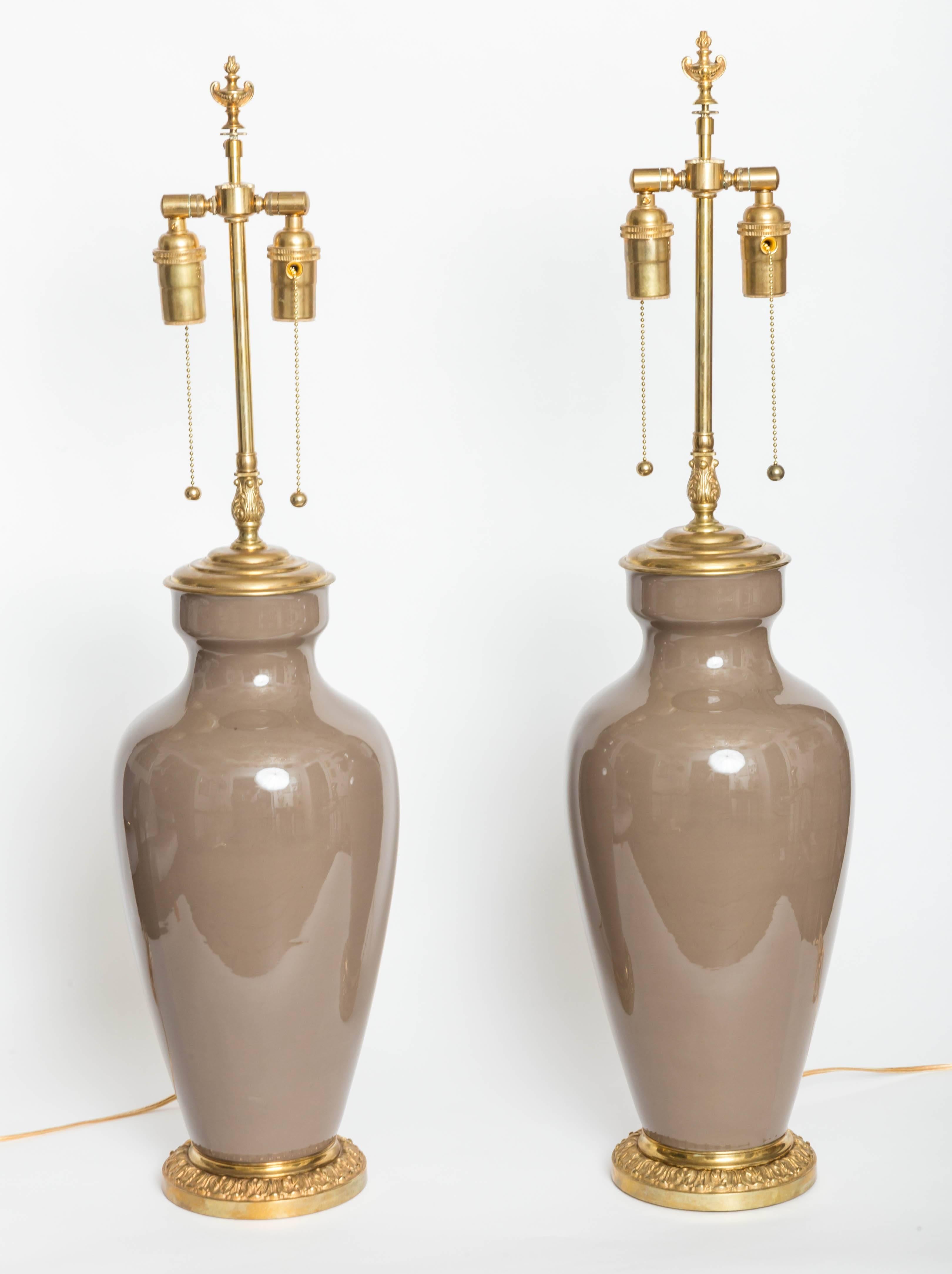 Pair of Greige urn form table lamps with decoratigve bases and finials
by Lenox.