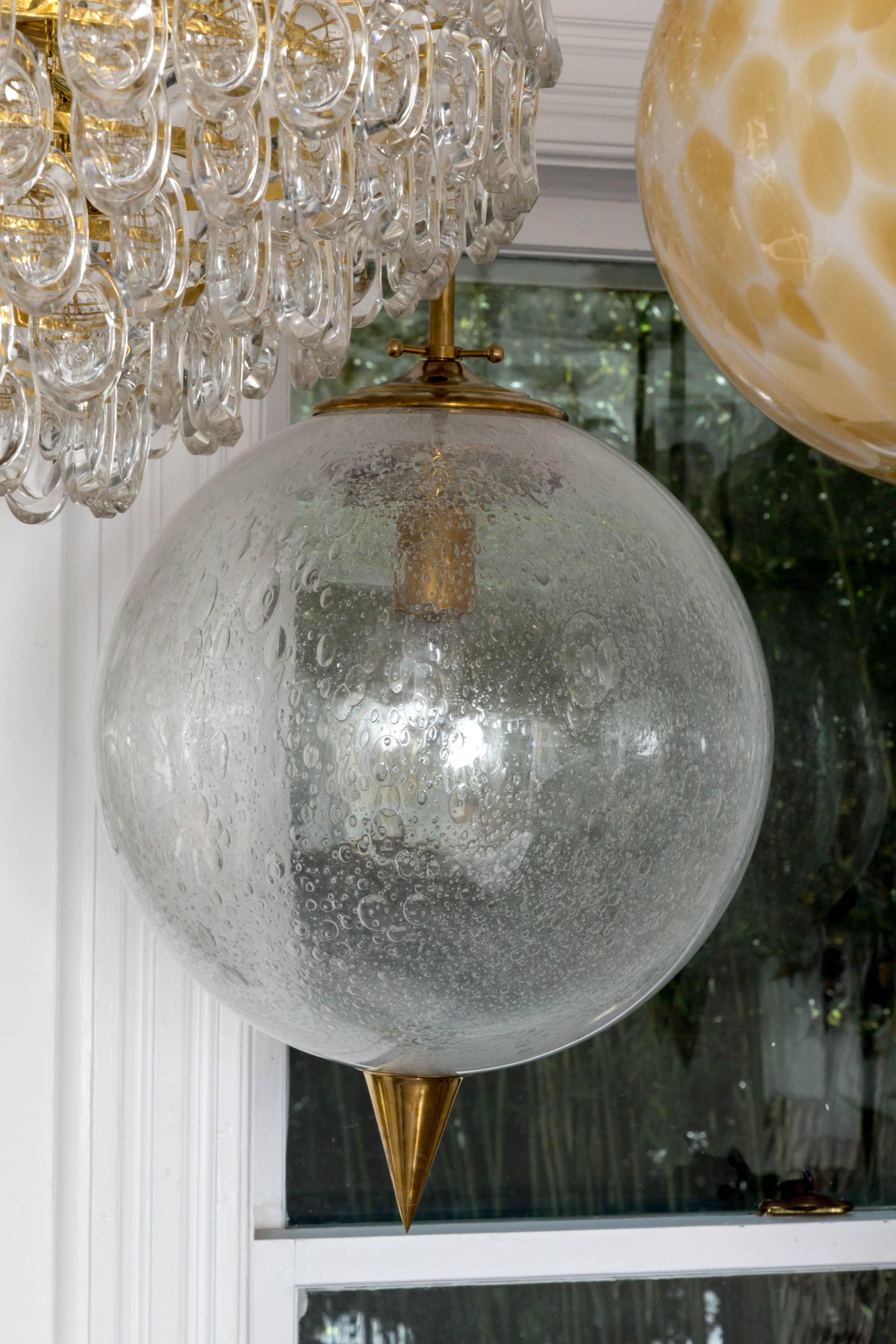 Modern Spherical Clear Glass Pendant with Inclusive Air Bubbles and Brass Details For Sale