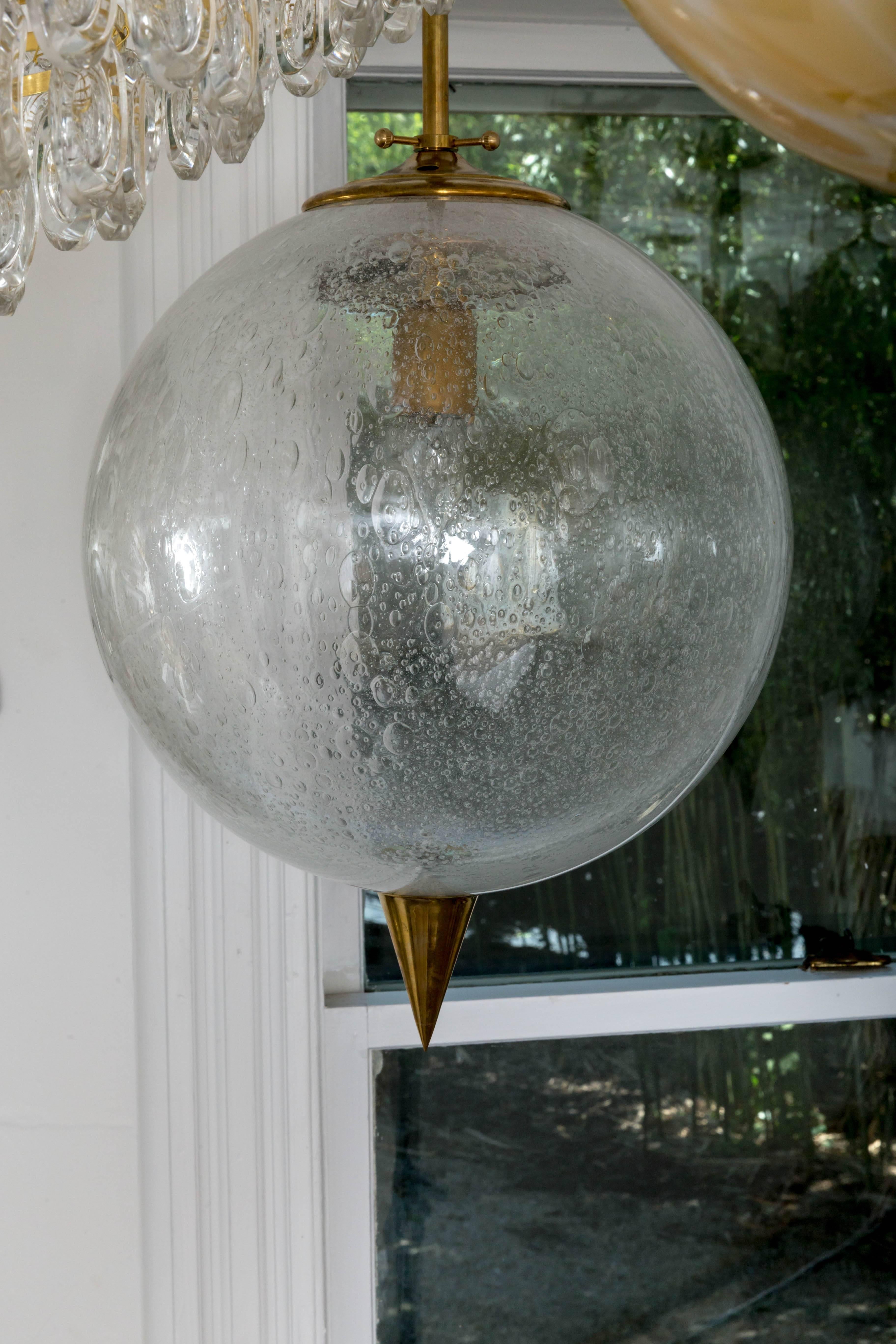 American Spherical Clear Glass Pendant with Inclusive Air Bubbles and Brass Details For Sale