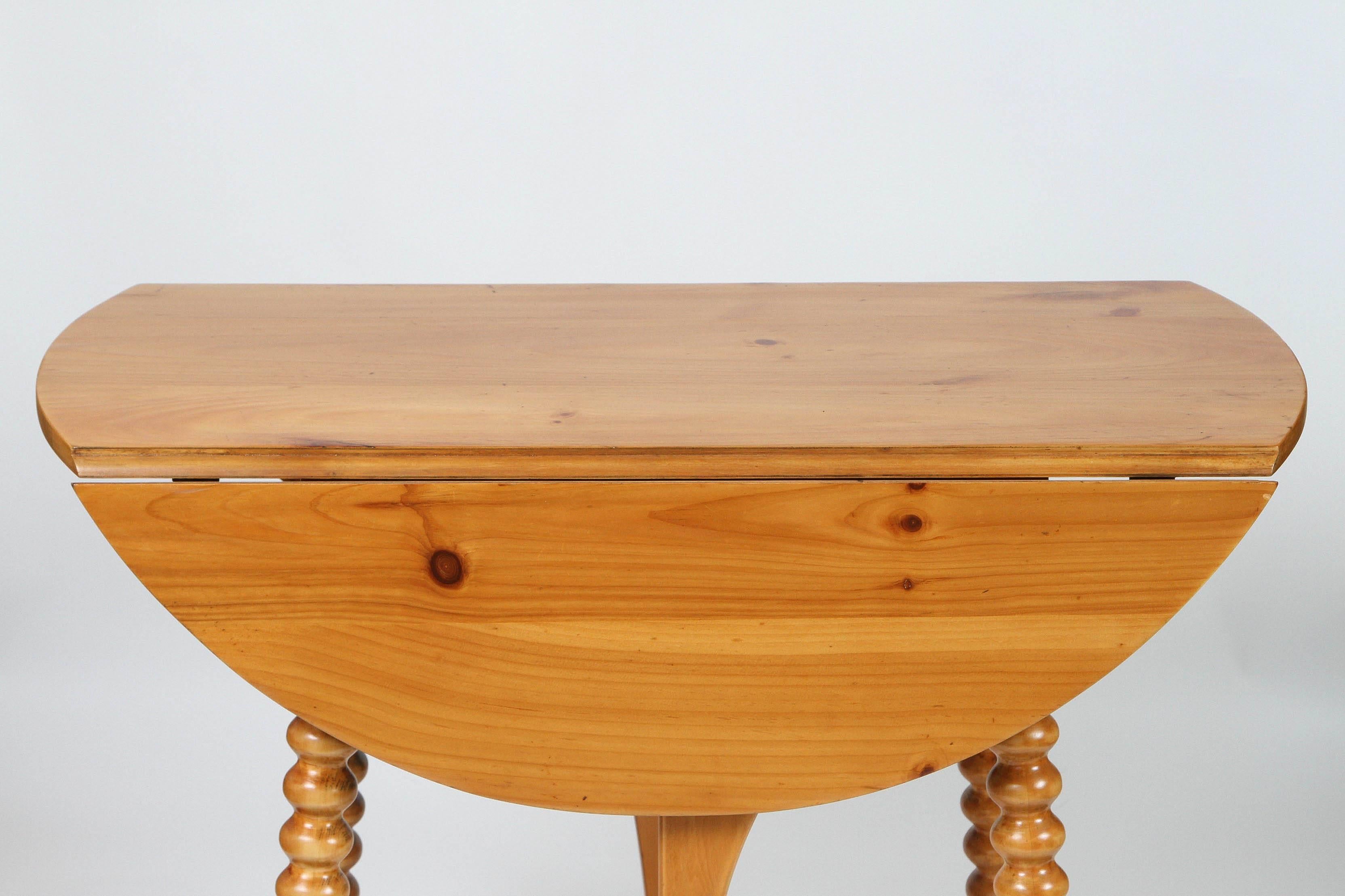 Newly refinished Vintage pine wood drop-leaf table with spool legs.