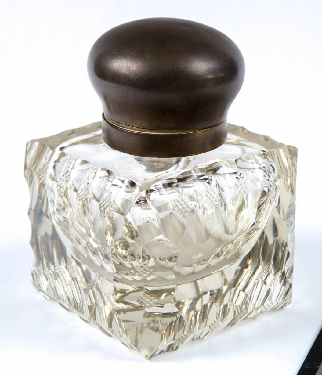1890 large American cut crystal inkwell with metal top with gold wash inside, and all original glass insert.
The crystal inkwell has brilliant cuts throughout with diamond embossed cuts four on every side of square.
Wear consistent with age of