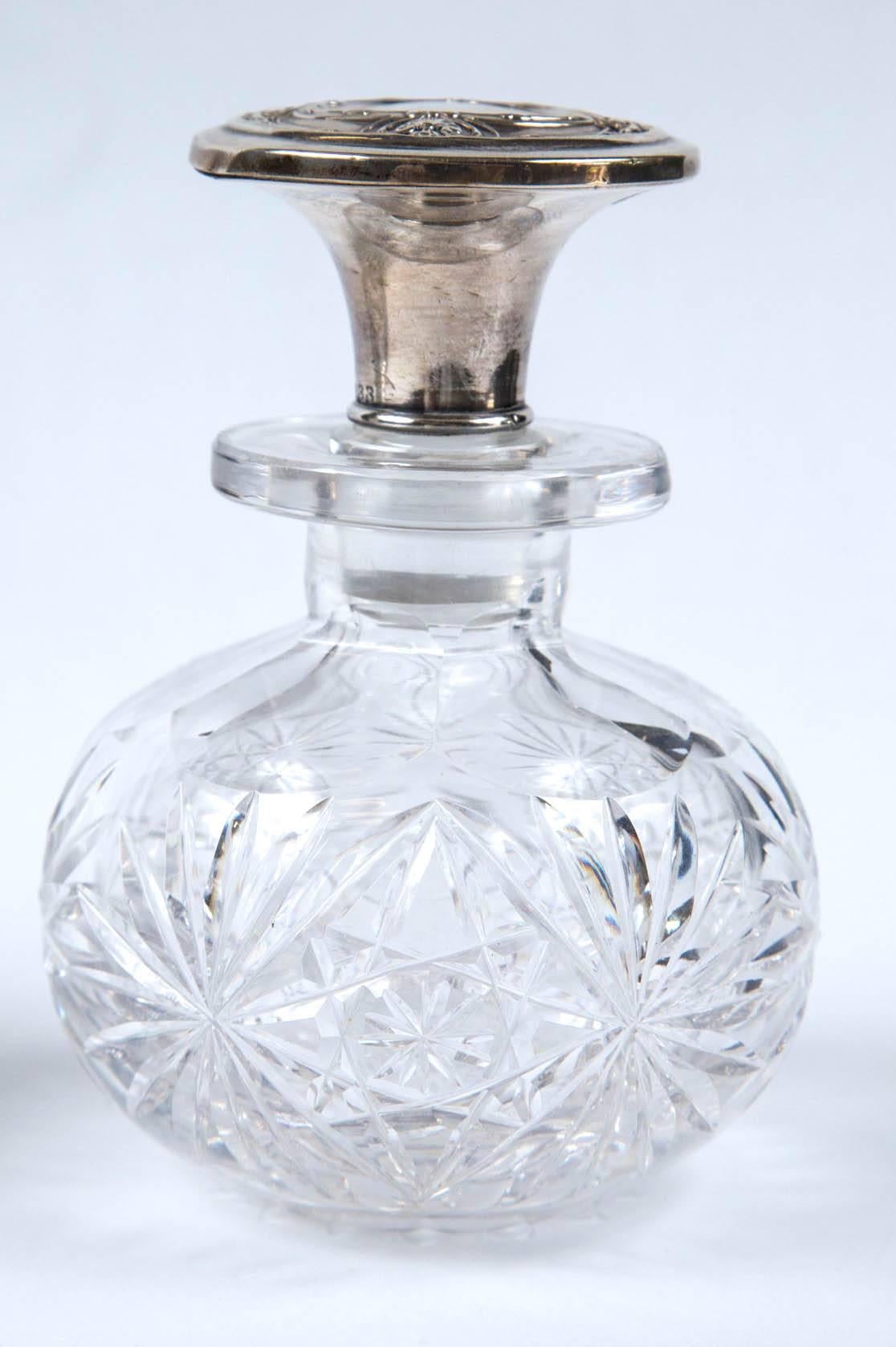 Pair of antique American 1890 sterling silver top perfume bottles, all cut crystal sunburst design in great condition, with matching sterling silver tops in good condition, with a beautiful matching design top for each bottle. S/N 833 matching on