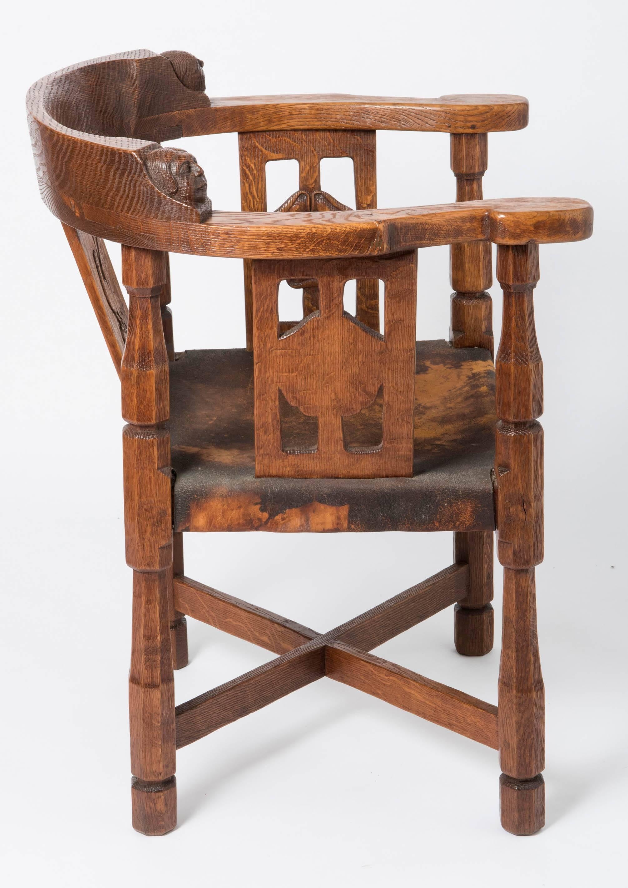A lovely early “Monk's " chairs by Robert Thompson- Mouseman (1876-1955)
Oak
With curved top rail and arms.
Carved with Monks head, above three panels, carved with a cipher and roses.
Raised on octagonal legs joined by an