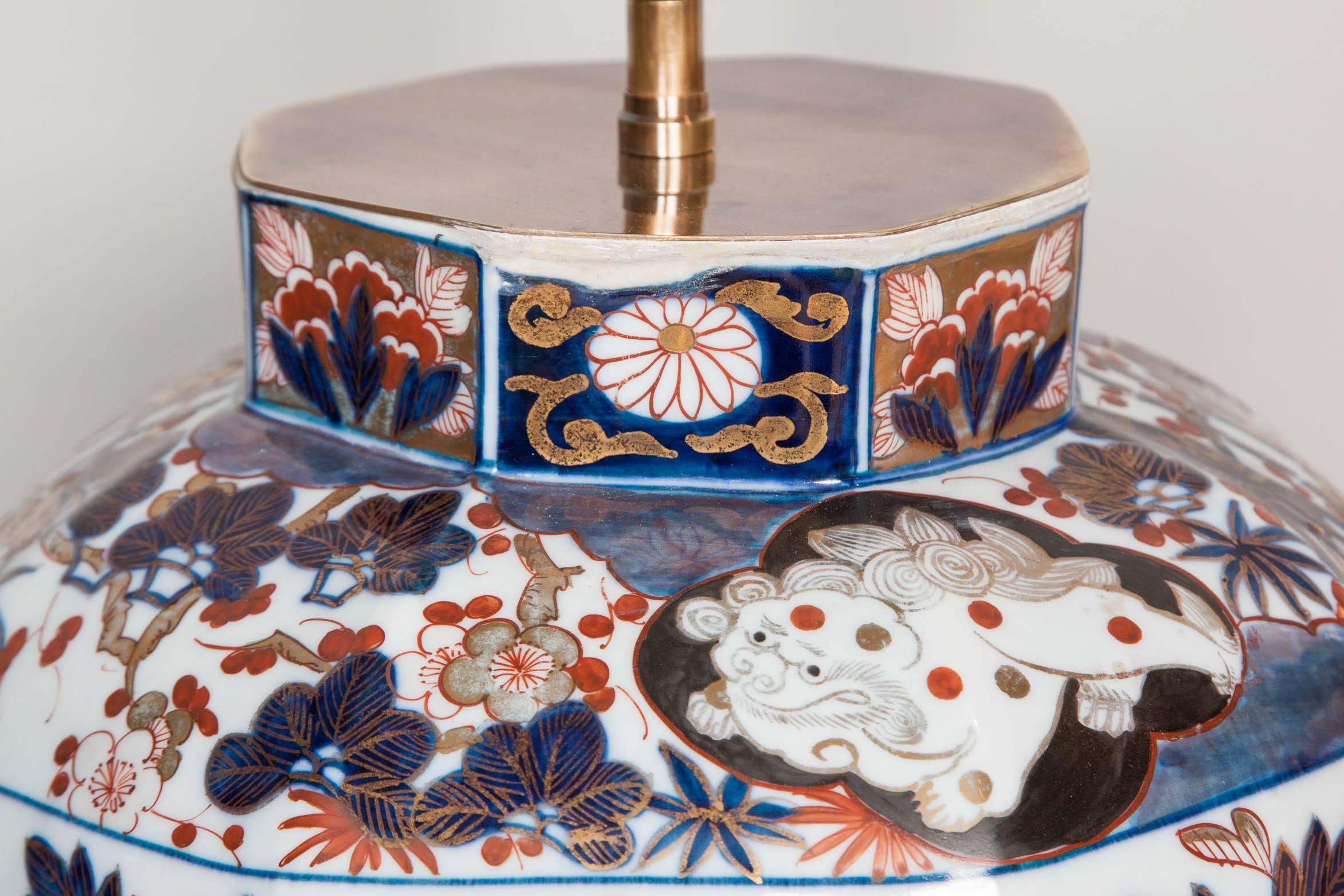 A really fine pair of medium sized early 18th century Japanese richly decorated Imari baluster vases of octagonal shape. Both vases have been lamped on hand-carved and water gilt wooden bases and fitted with antiqued brass plates with light