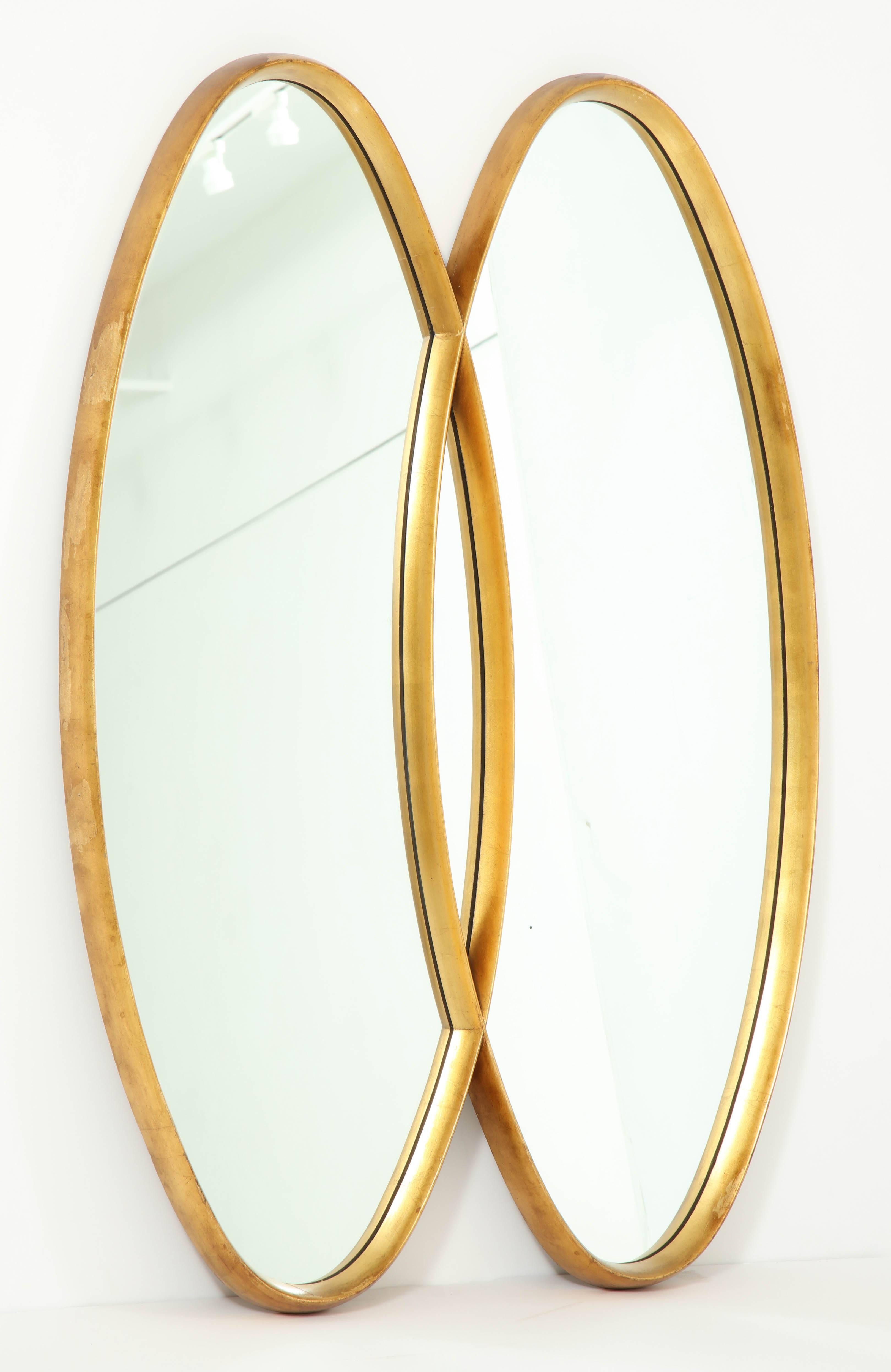 Decorative gold leaf oval wall mirror, circa 1950.