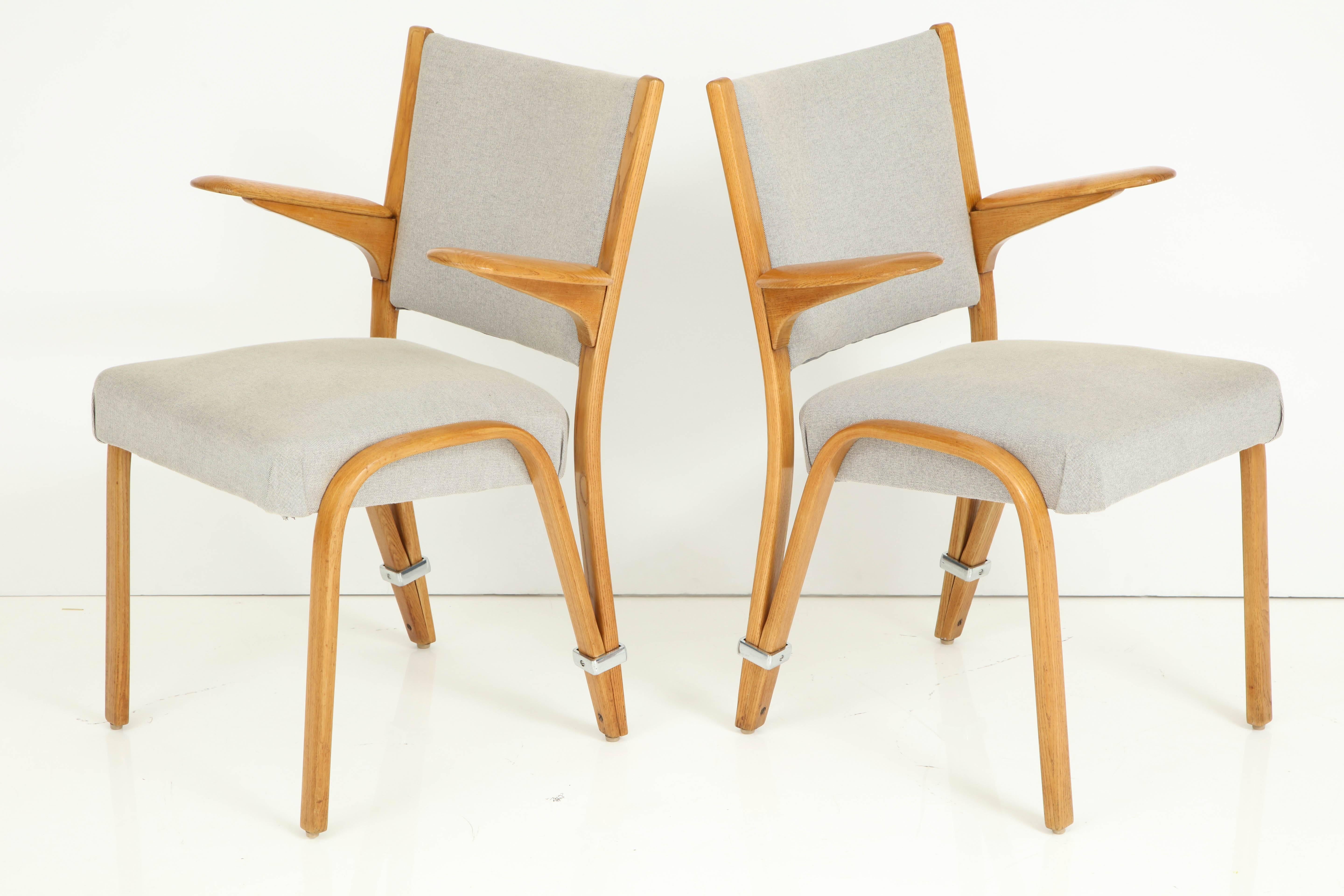 Rare pair of French 1950s Hugues Steiner armchairs, each having paddle form arms and upholstered backs and seats.