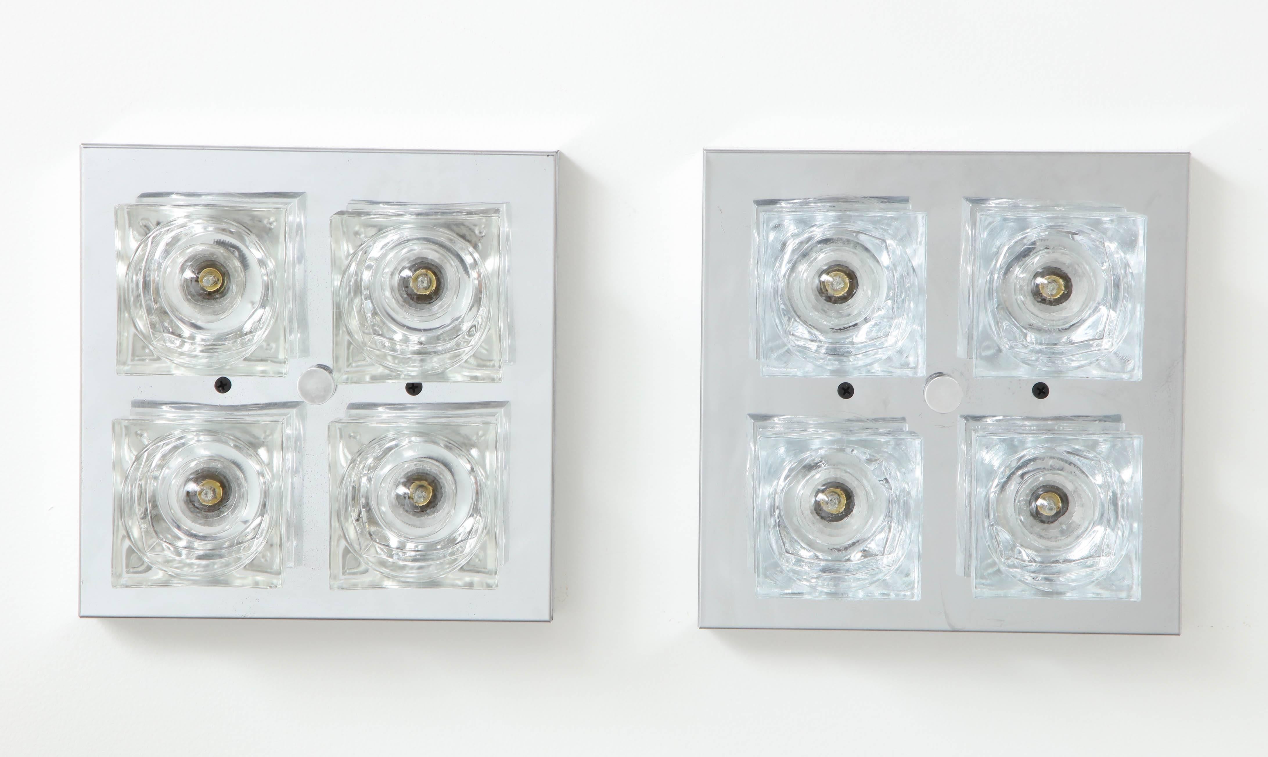 Pair of chrome wall sconces or flush mounts by Sciolari.
The fixtures have been newly rewired for the US each taking a candelabra light bulb with a 25 watt max totaling 100 watts per fixture.
The fixtures are in great vintage condition.