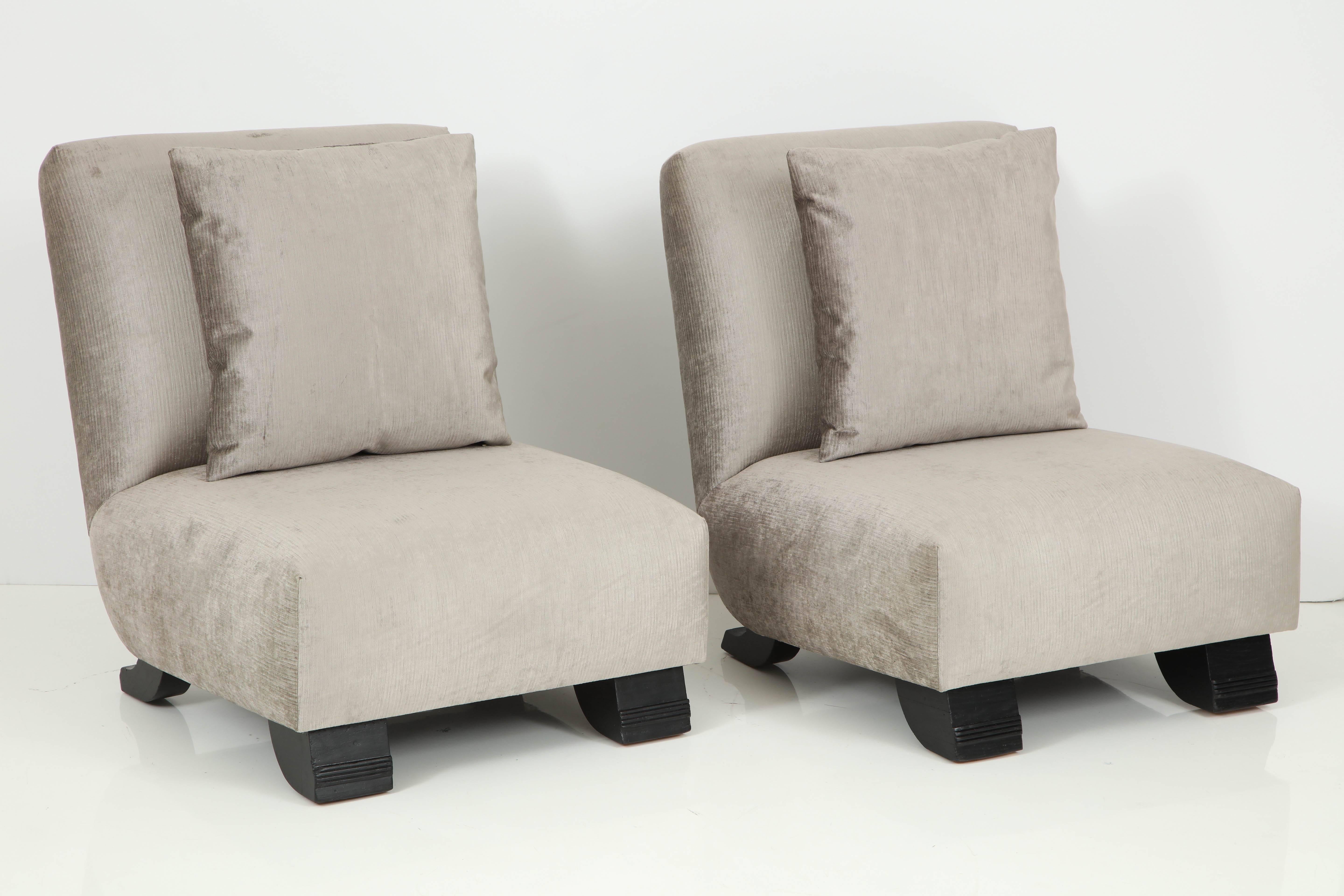 Elegant pair of slipper chairs by James Mont.
The chairs have been newly reupholstered in a silvery gray velvet fabric and each is accompanied by a separate back cushion.