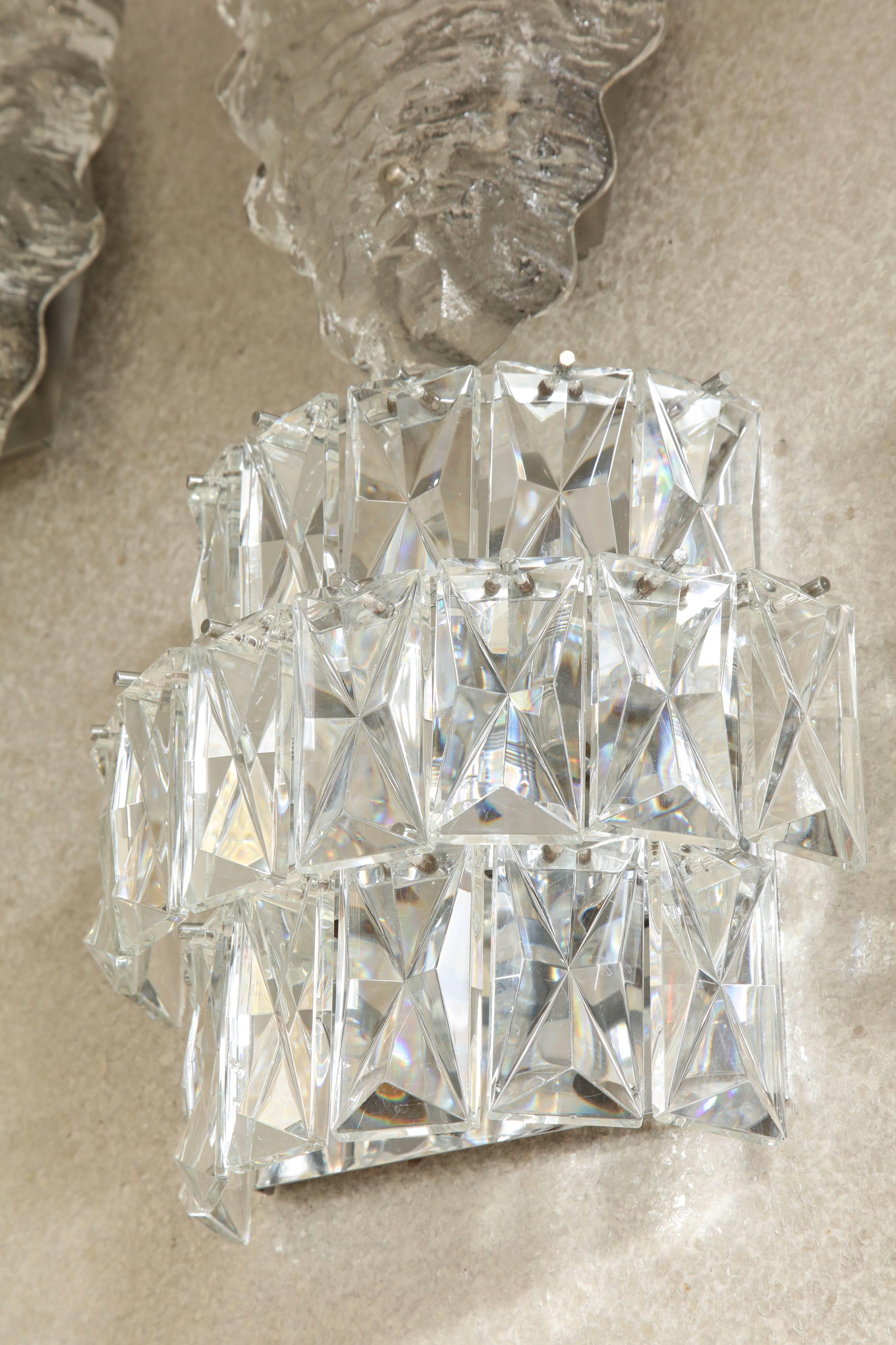 Glamorous pair of deep faceted rectangular crystal prism sconces on nickel back plates. Rewired for use in the USA, each sconce uses three candelabra type bulbs.