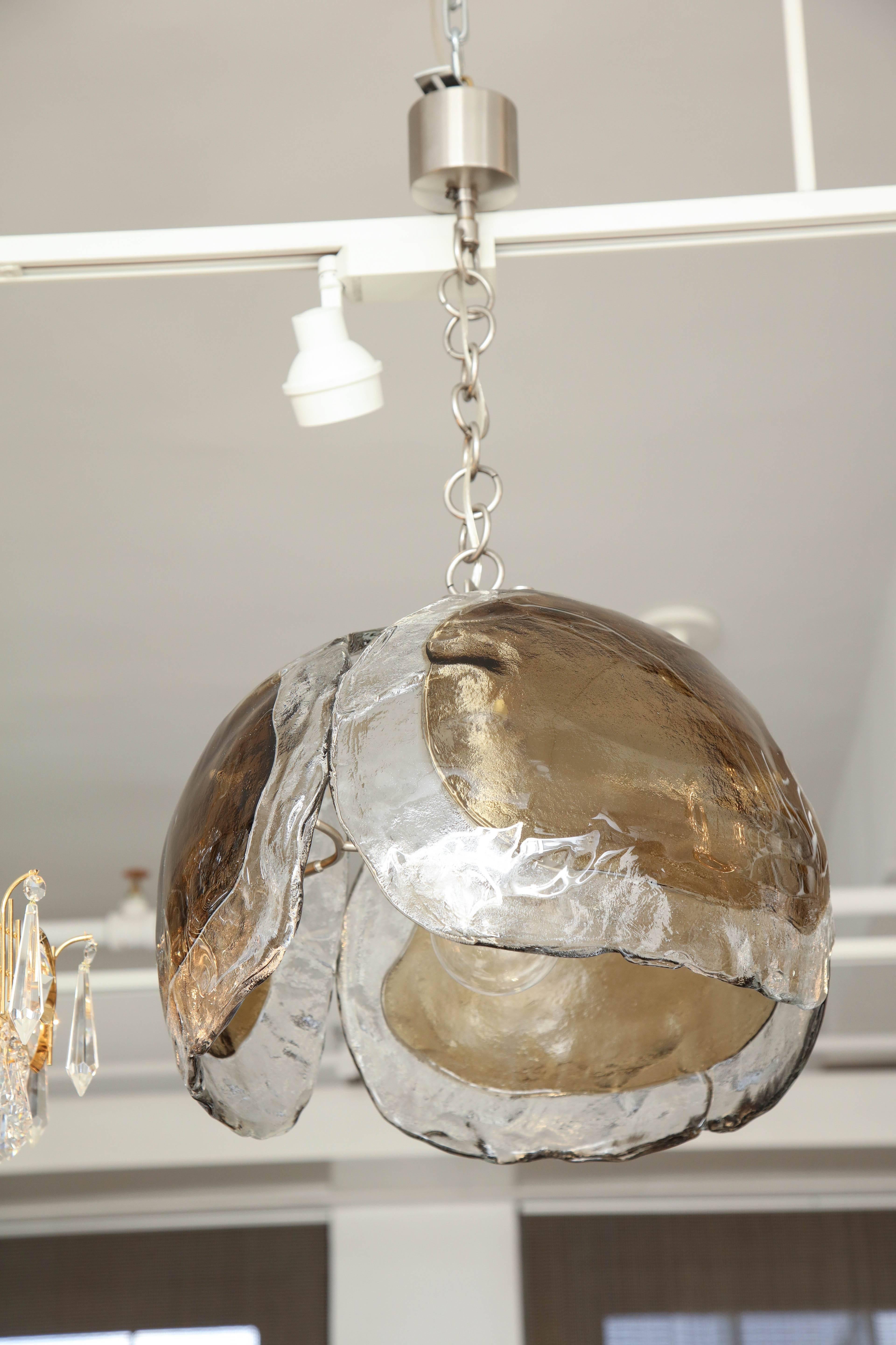 Mid-Century light pendant with clear and smoky topaz glass elements suspended on a satin nickel O ring chain and canopy. Rewired for use in USA, uses one Edison type bulb.

Glass portion measures 14