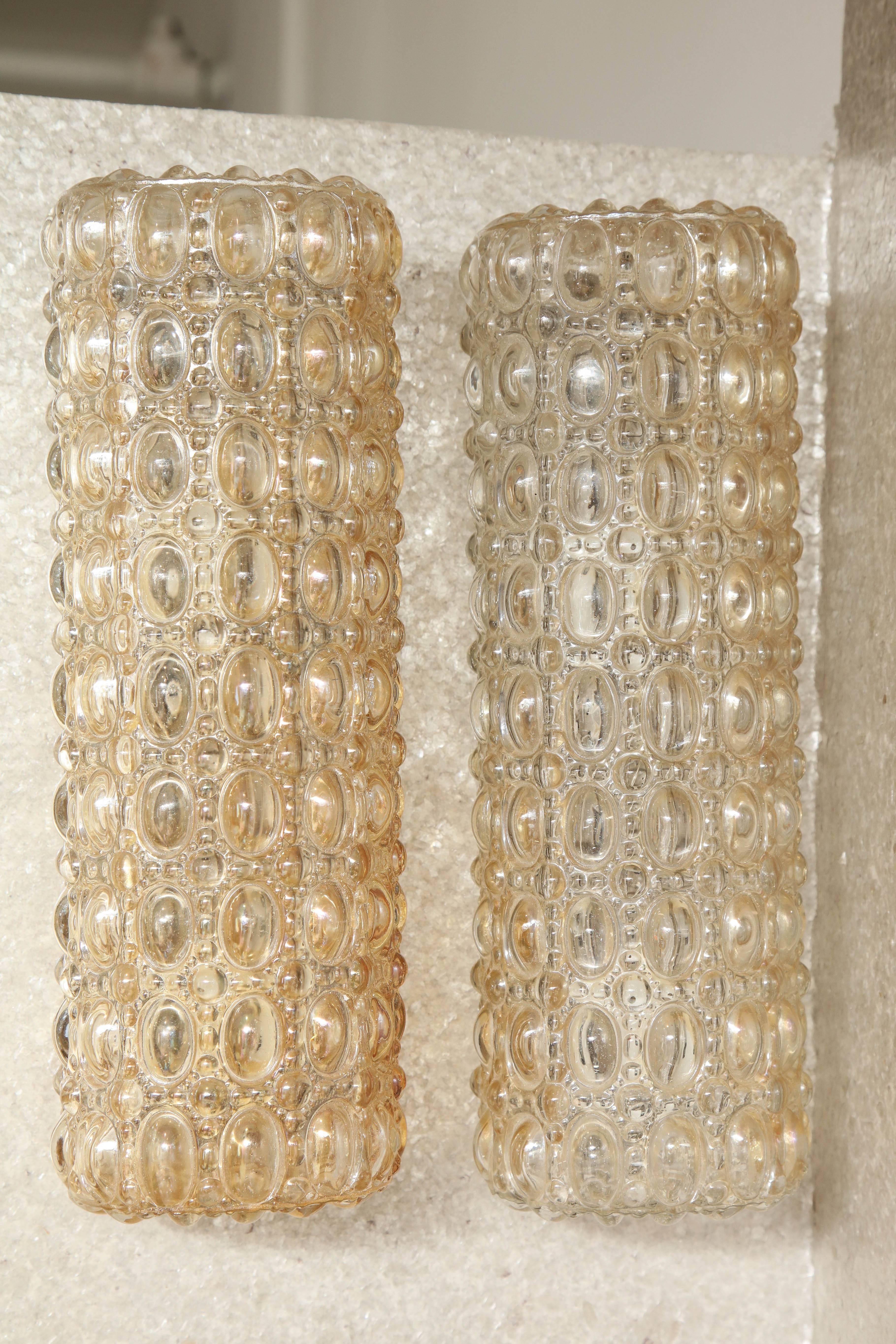 Pair of rectangular champagne colored glass sconces with a raised oval bubble pattern on satin nickel plates. Rewired for use in the USA. Each sconce has two-light sources.