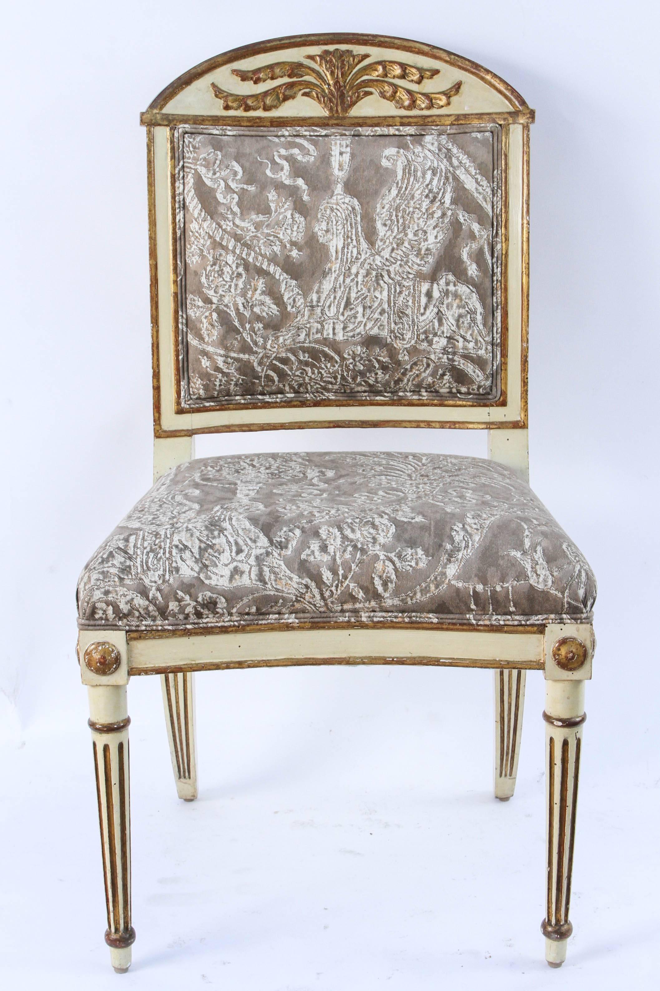 Group of twelve 19th century Italian gilded, carved and painted. Saber dining chairs. Nine are original and three are reproductions.