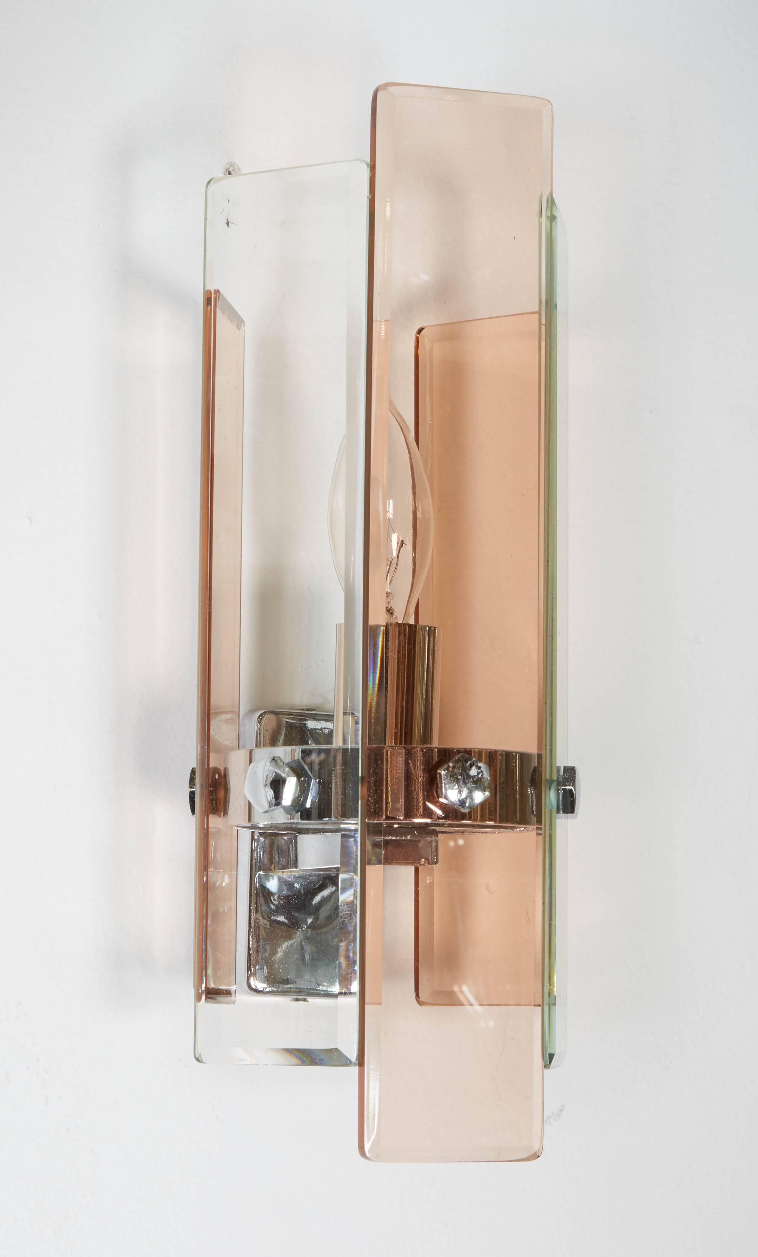 A pair of 1970s Art Deco revival sconces in polished chrome, clear and coral glass panels. Each sconce has a long central coral panel flanked by two shorter clear panels in turn flanked by two shorter coral panels. A total of five glass panels in a