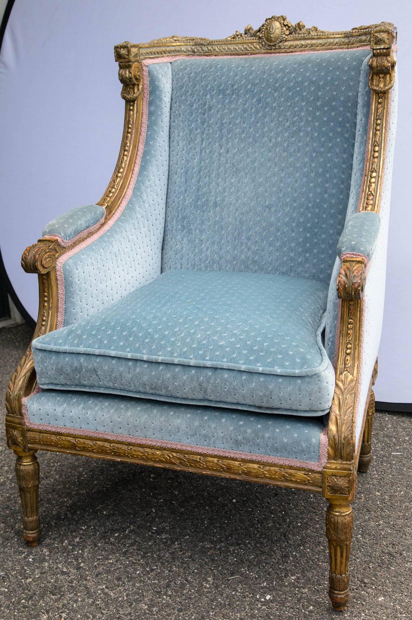 This chair is fully carved with a central crest on the top rail, acanthus leaves, flowers, palmettes and more. Fully upholstered.