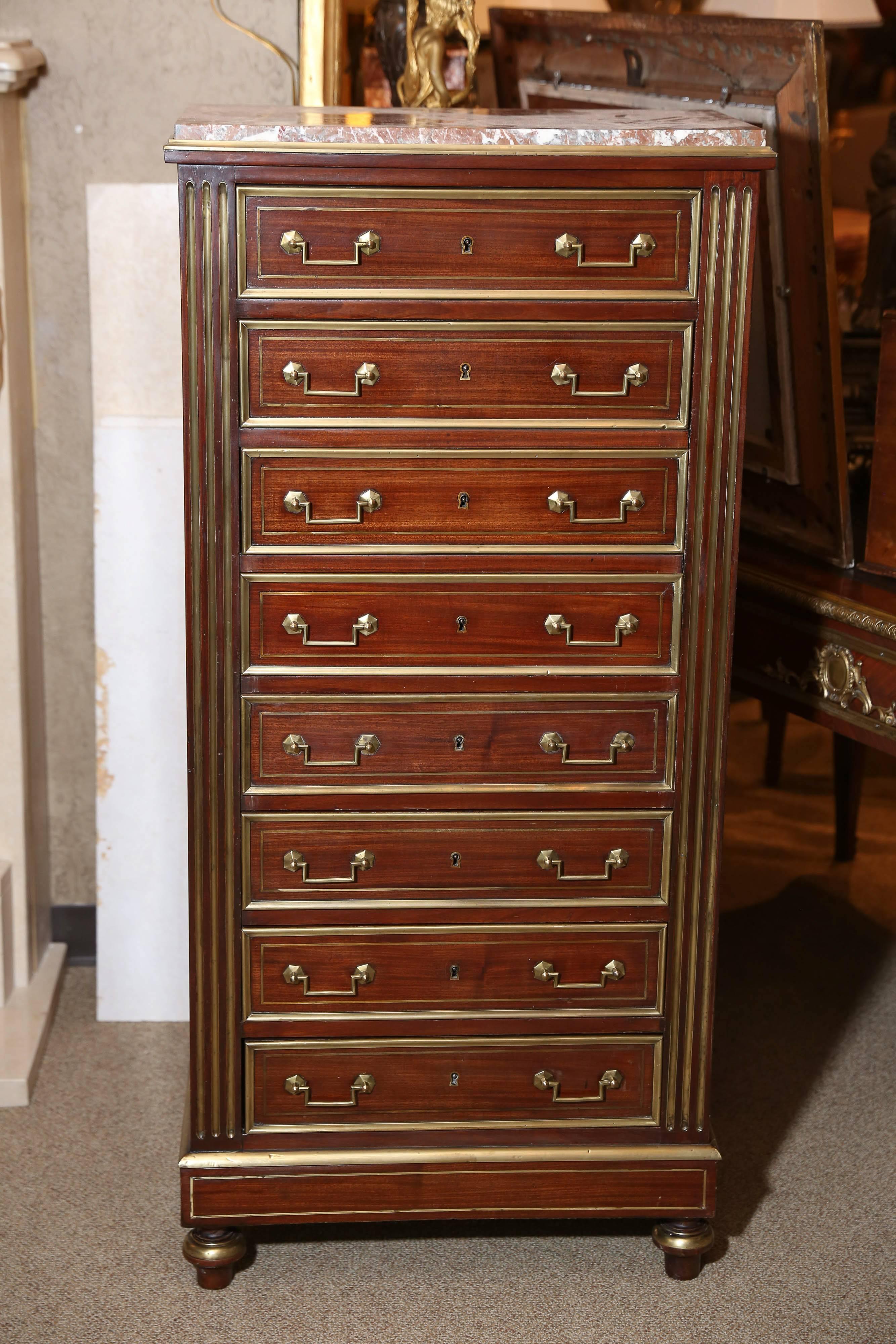 Excellent mahogany tall chest fitted with eight drawers, all with brass banding,
Raised on bulbous feet. The marble top is rectangular and inset on top.