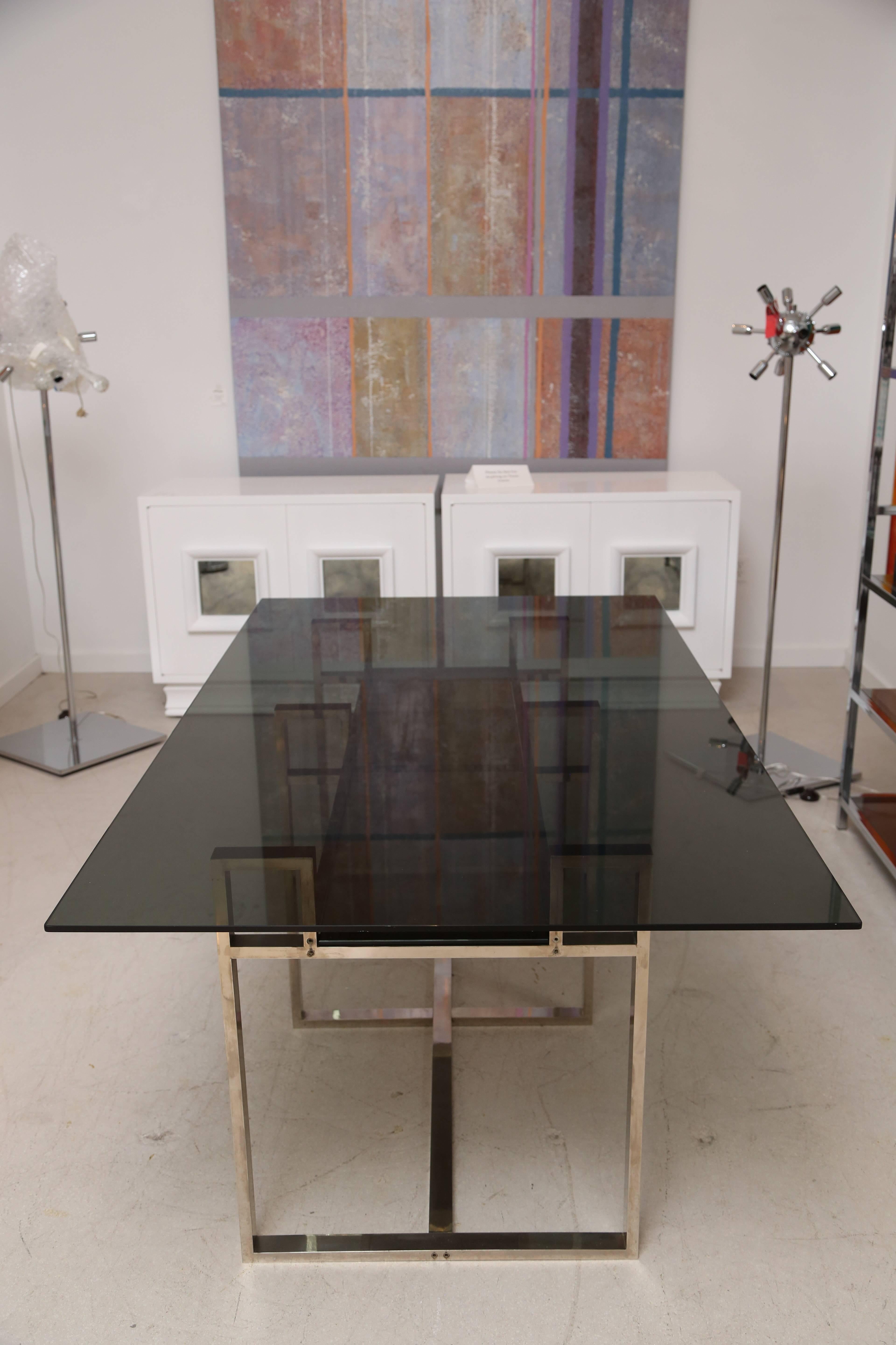 Milo Baughman chrome geometric dining table with original smoked glass top and smoked glass floating in lower tier of table. 
Base alone measures: 55