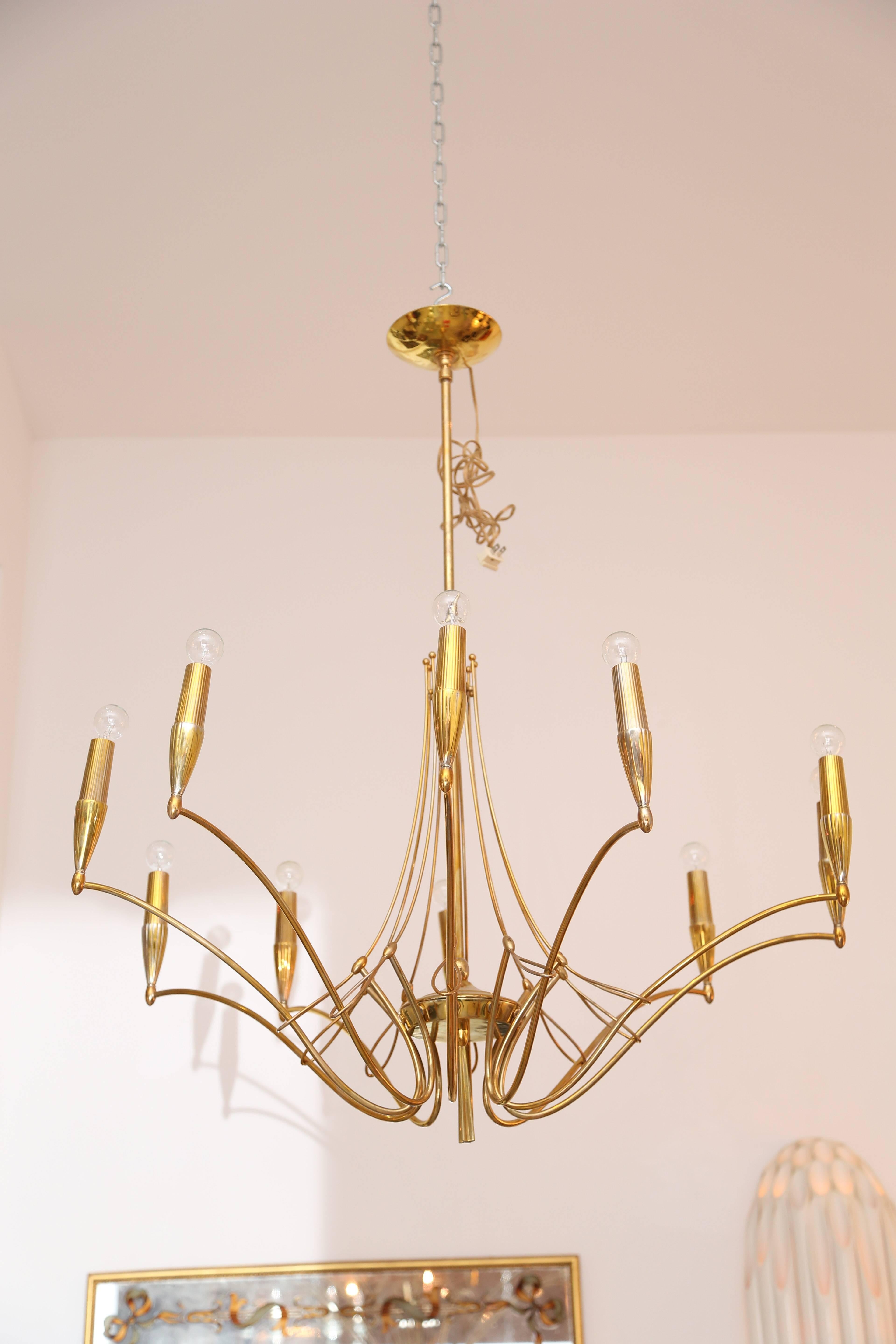 Ten-arm brass chandelier with ten sockets that house candelabra size bulbs.
The fixture has been rewired for US standards.