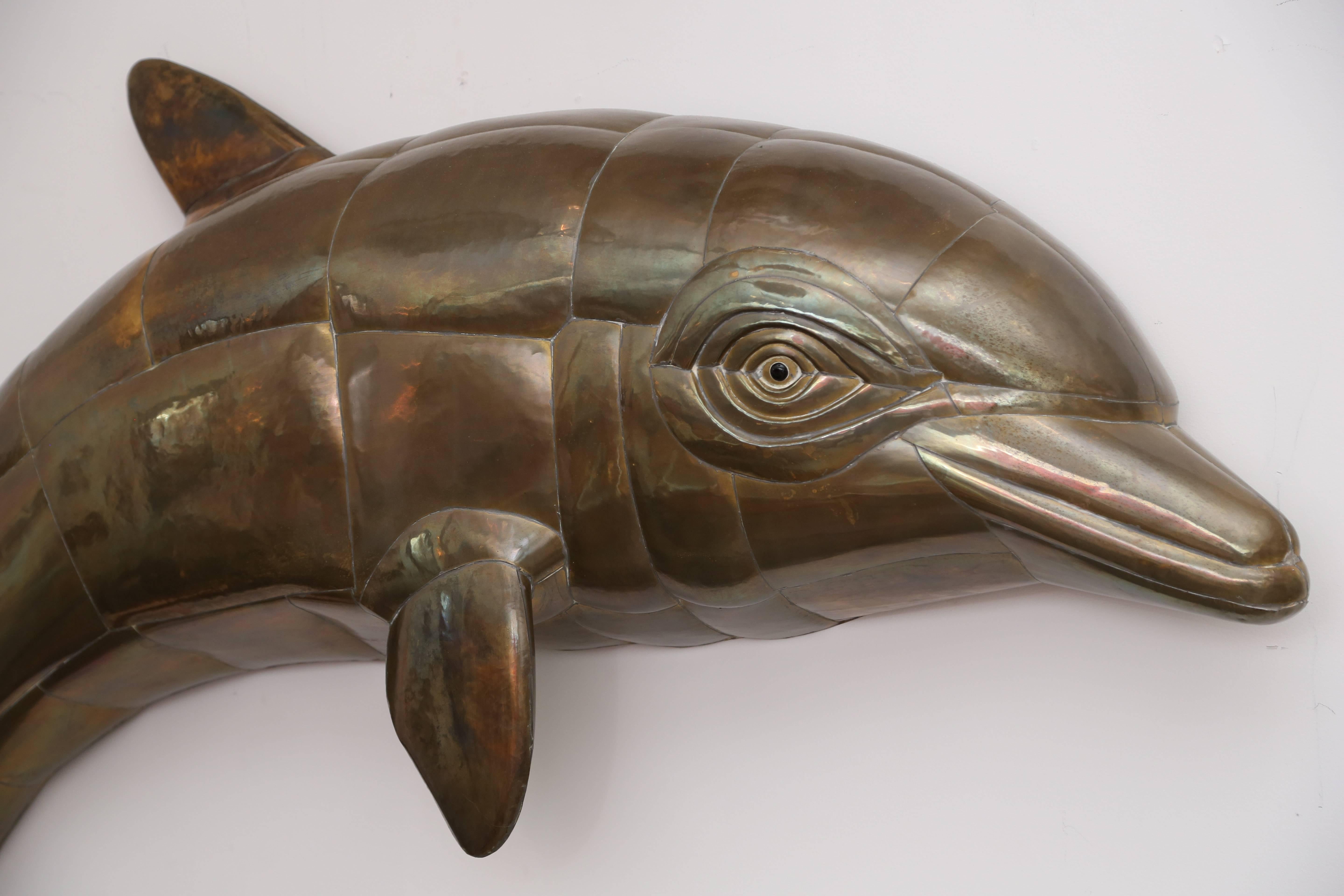 Huge Sergio Bustamante jumping dolphin mixed metal wall sculpture.