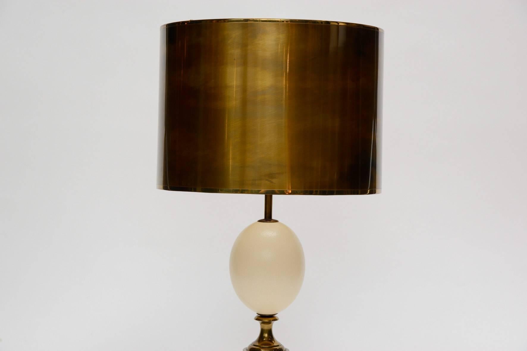 Table lamp stamped by Maison Charles made of an ostrich egg set in patinated brass with matching shade.