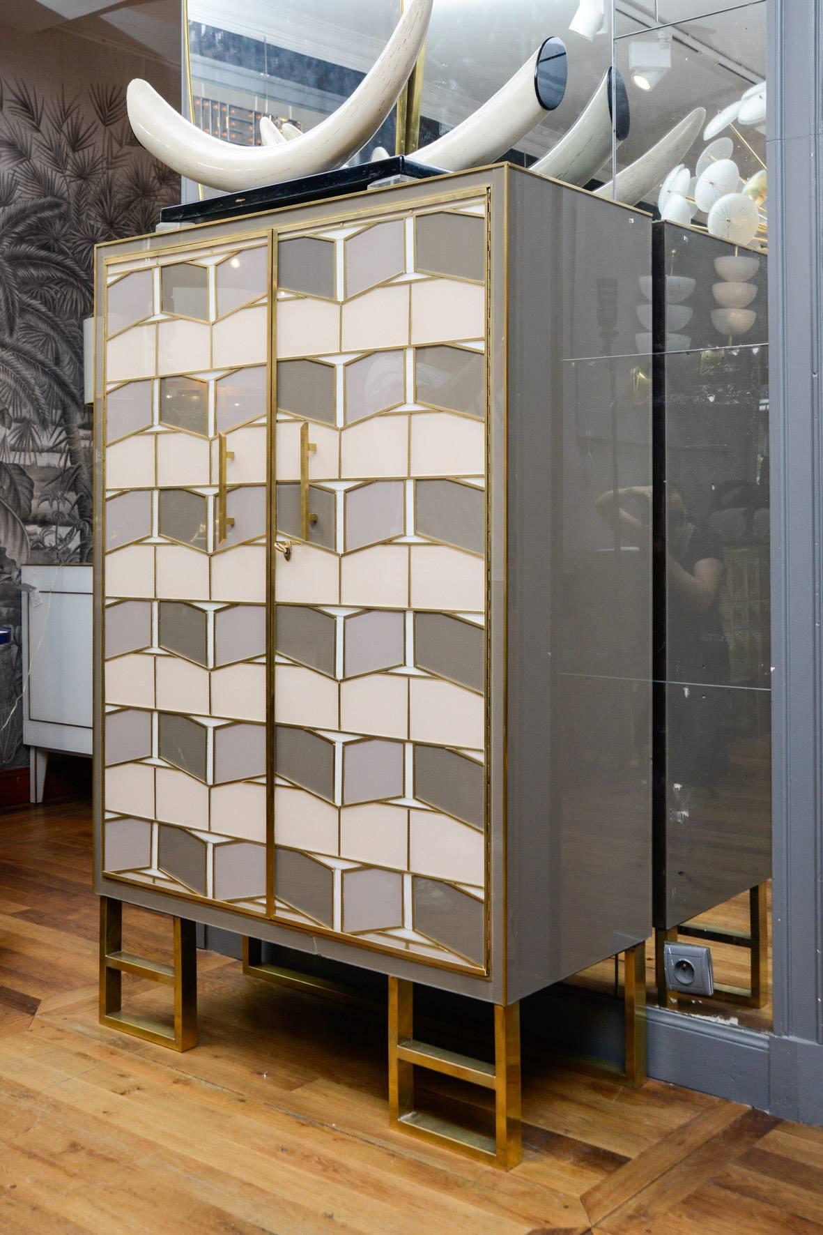 Brass and colored mirror cabinet, two doors, inside with mirror shelves.