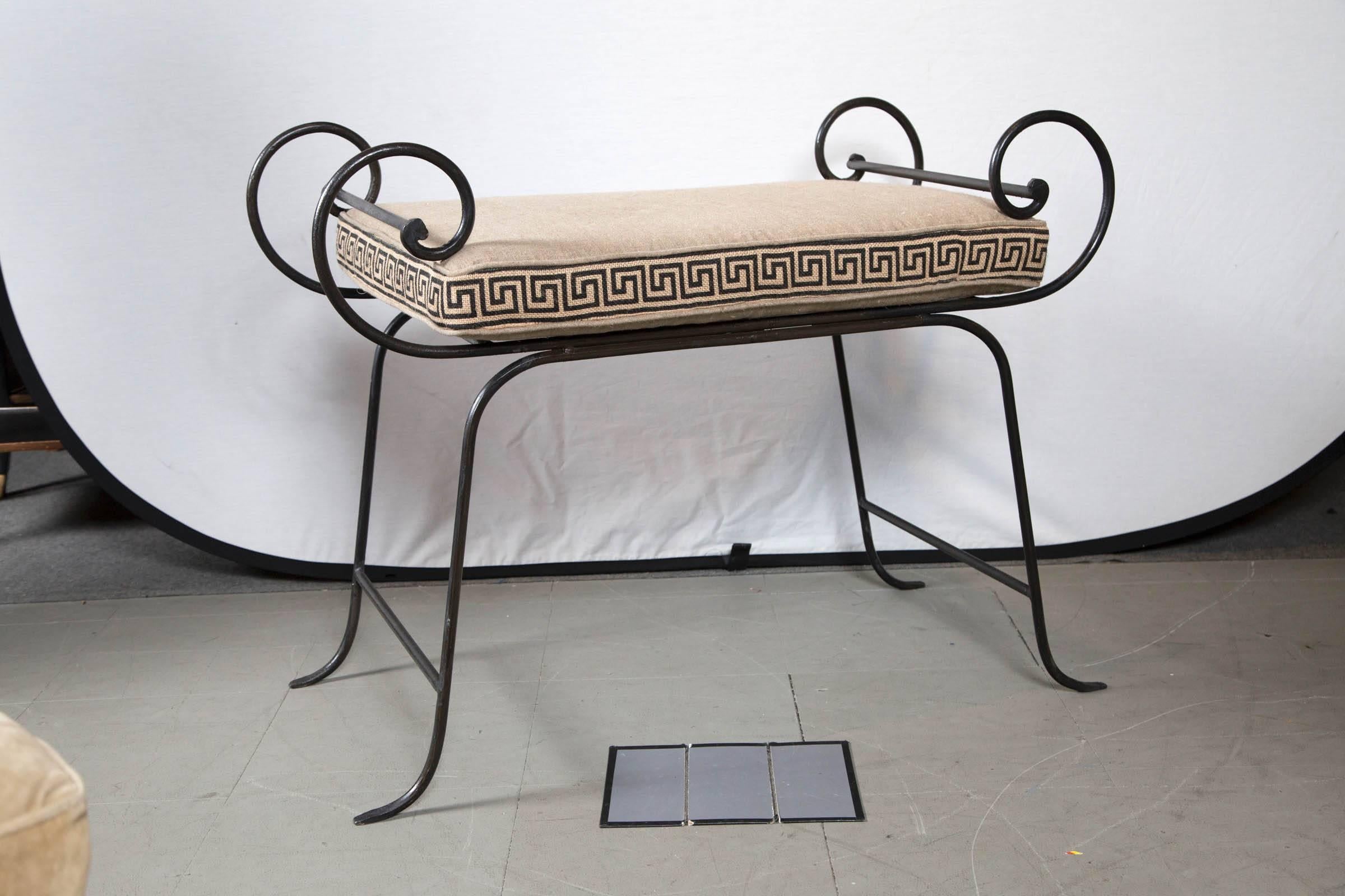 Simply elegant pair of Mid-Century wrought iron benches with cushions embellished with a Greek key design.