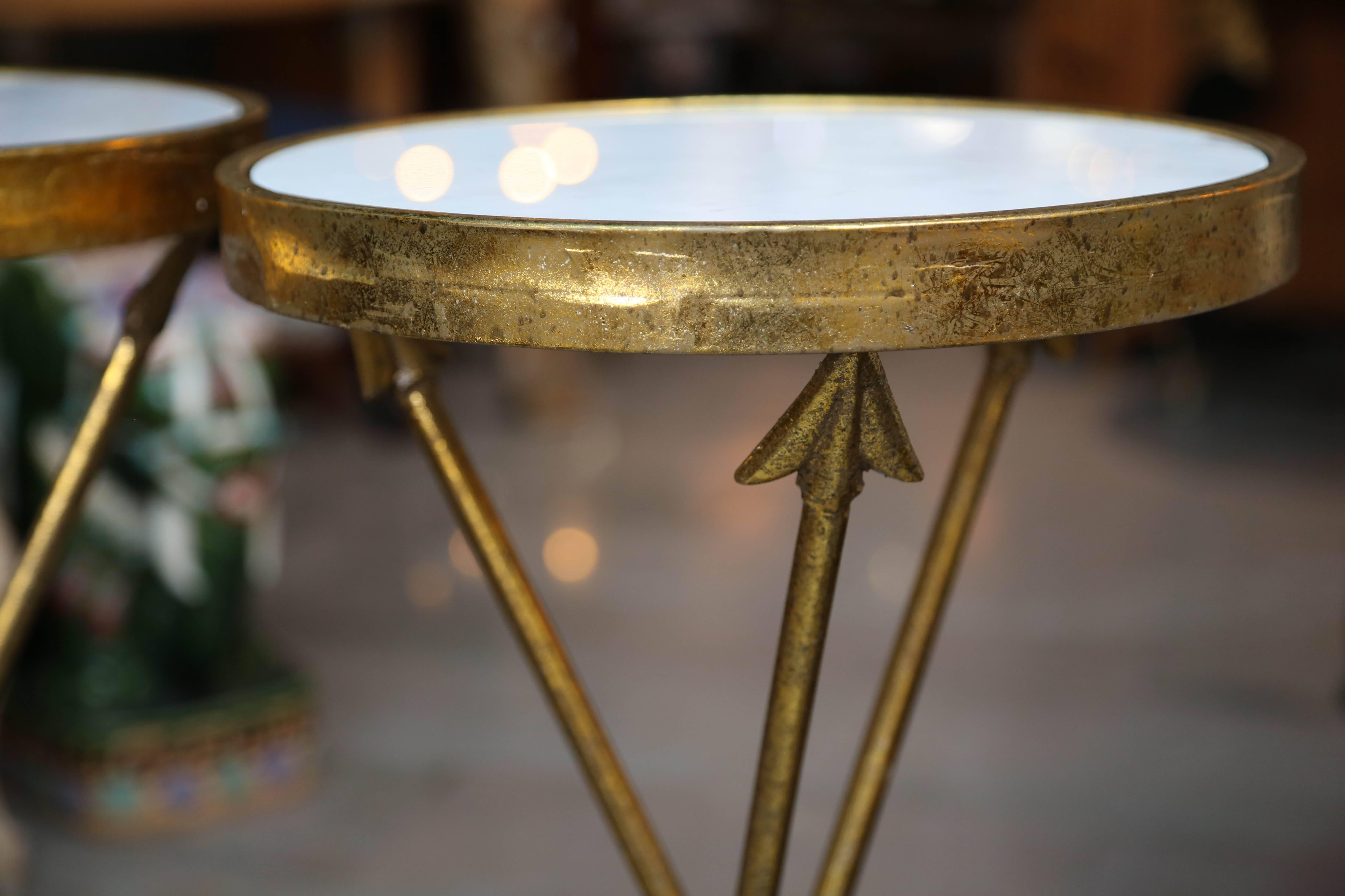 A fanciful pair of gilt appointed stands with tripod bases of arrows. The tables are inset with white Italian marble [14
