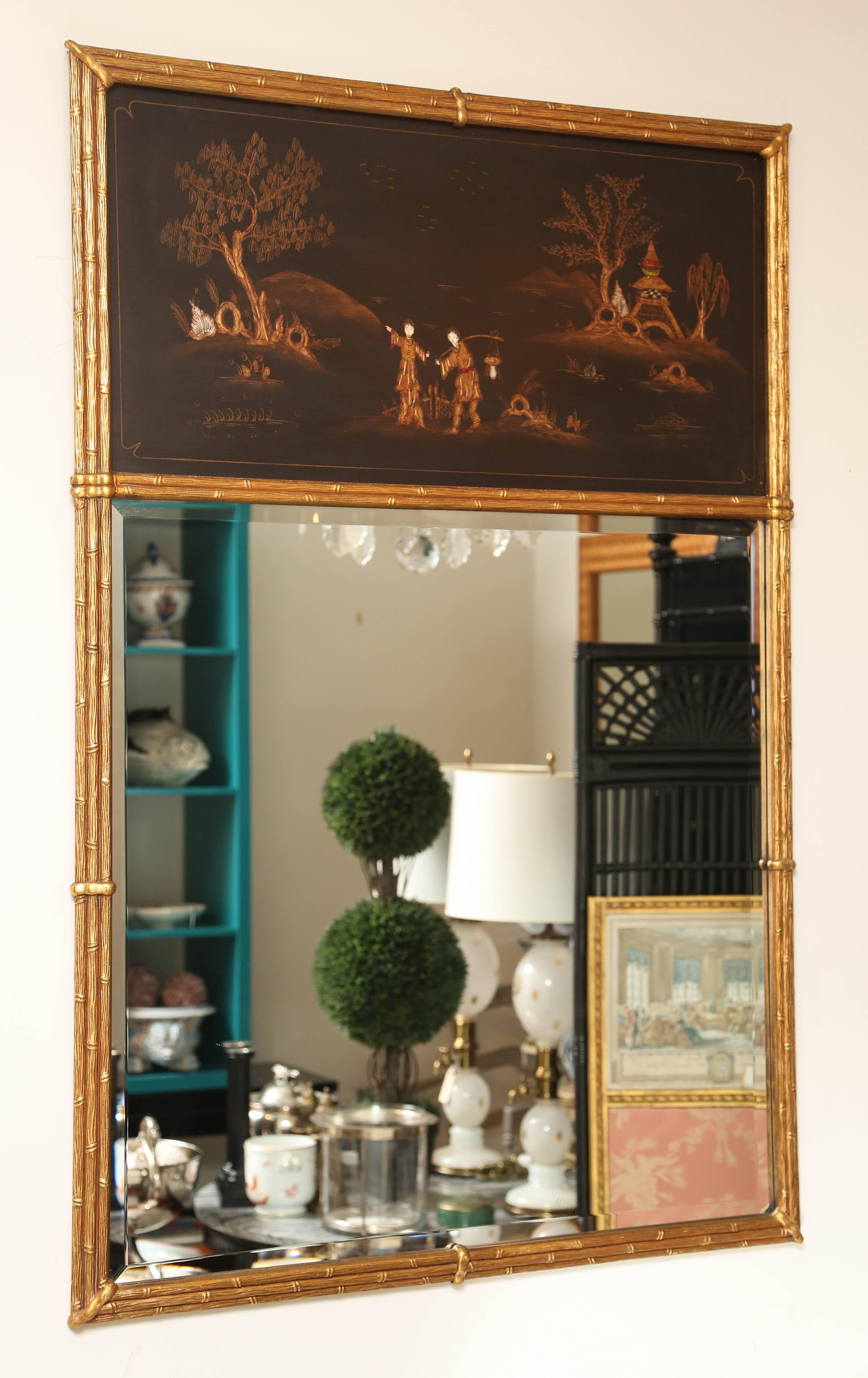 Classic chinoiserie trumeau mirror with lovely oriental painted scenery. Gilded wood faux bamboo frame.