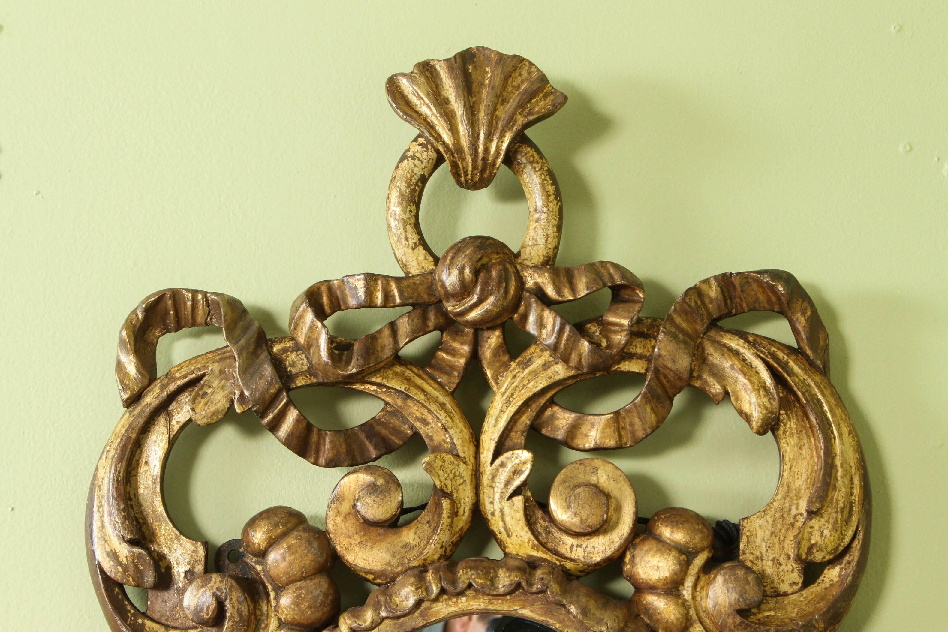 A beautiful elaborately carved French gilt mirror, circa 1800 in the style of Rococo.