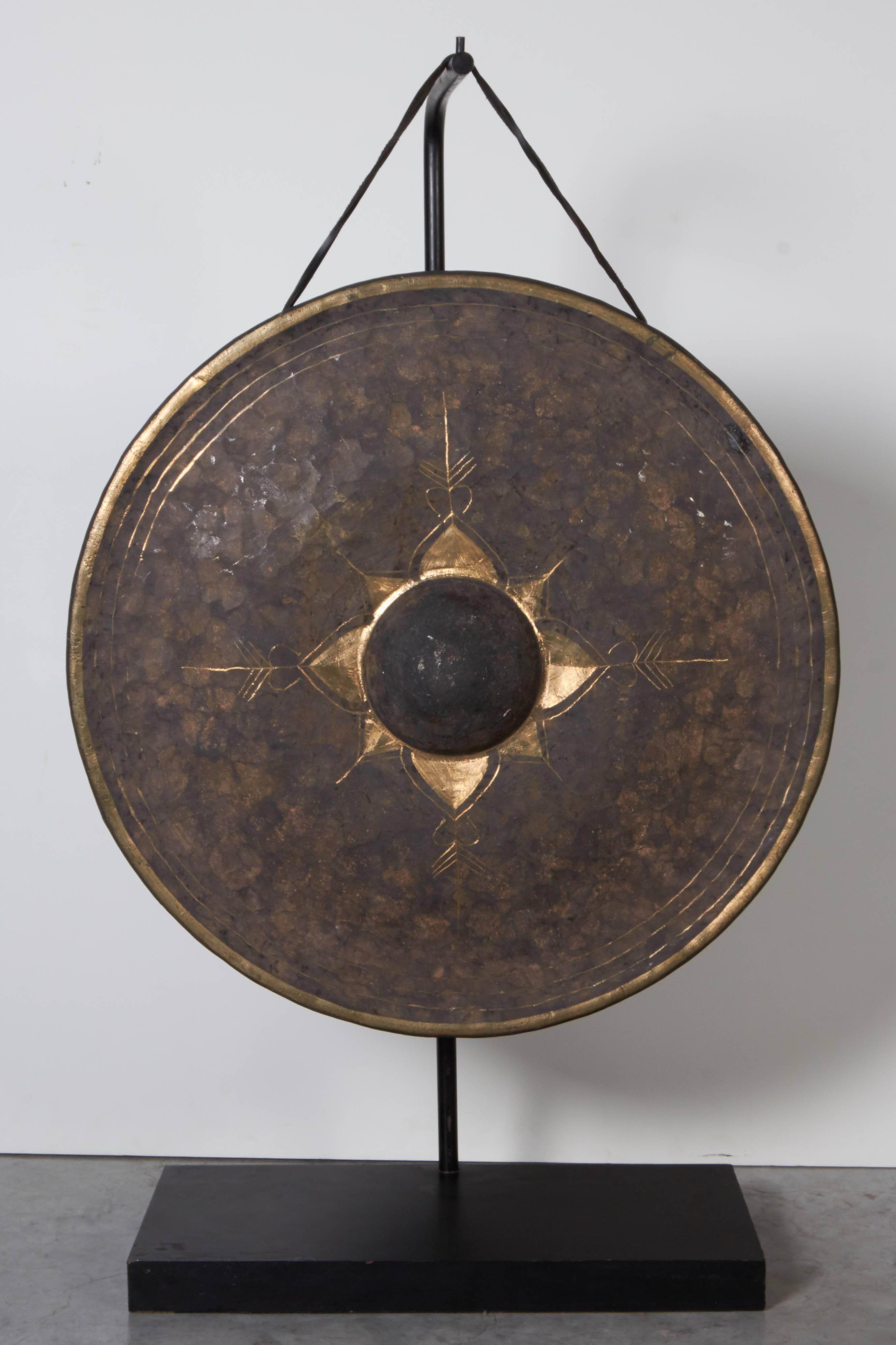 A late 19th century antique Burmese brass temple gong on a custom stand. This gong displays a beautiful patina and has a long lasting, calming and soothing sound. Includes mallet.
Dimensions on the stand: L 18, D 9, H 36. Dimensions of gong: Dia