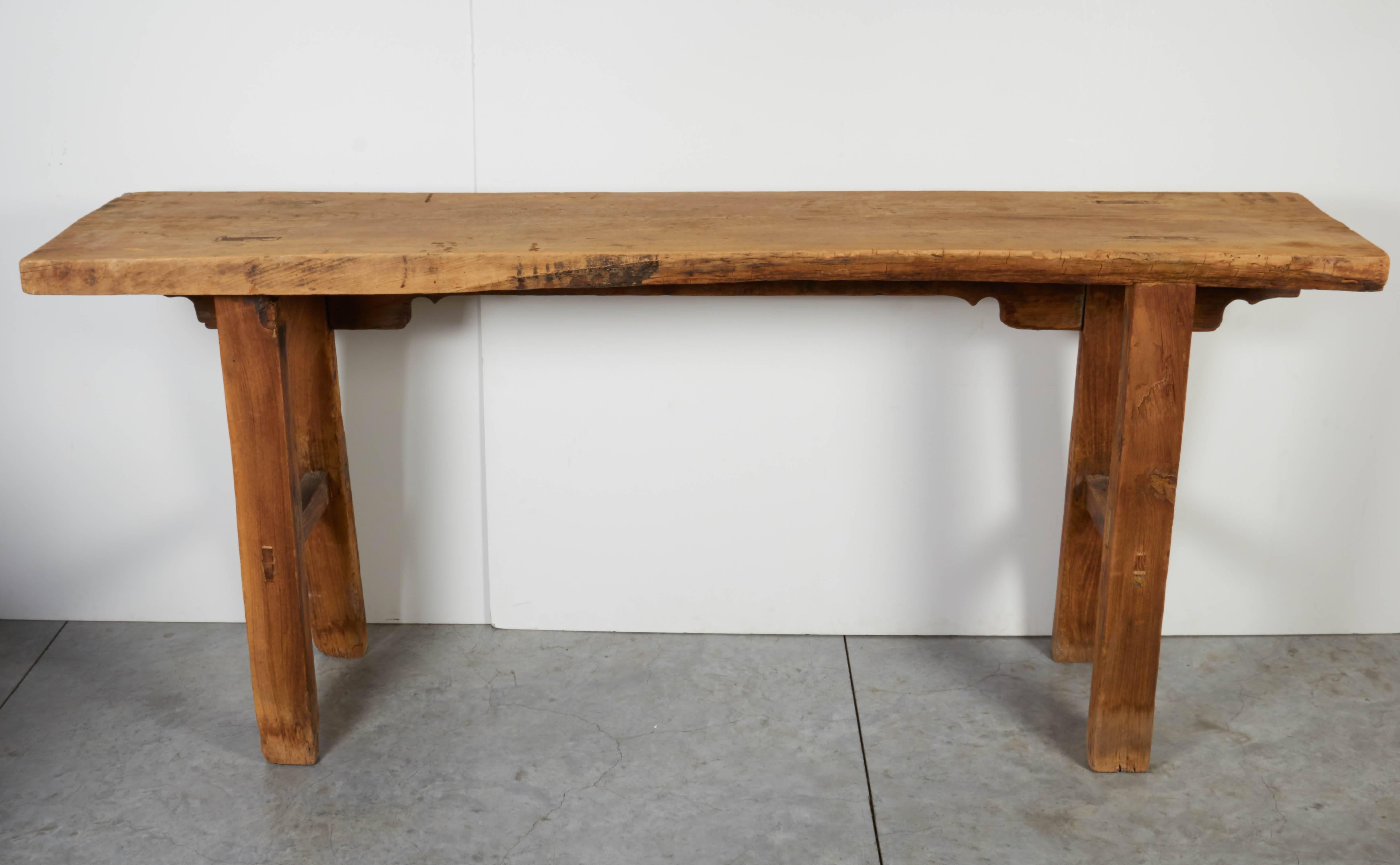 An unusual double sided vintage Chinese farm table constructed from a very thick century old tabletop and sturdy legs. Each side presents a different look. One side is a simple farm table design. The other side presents Classic Chinese wine table