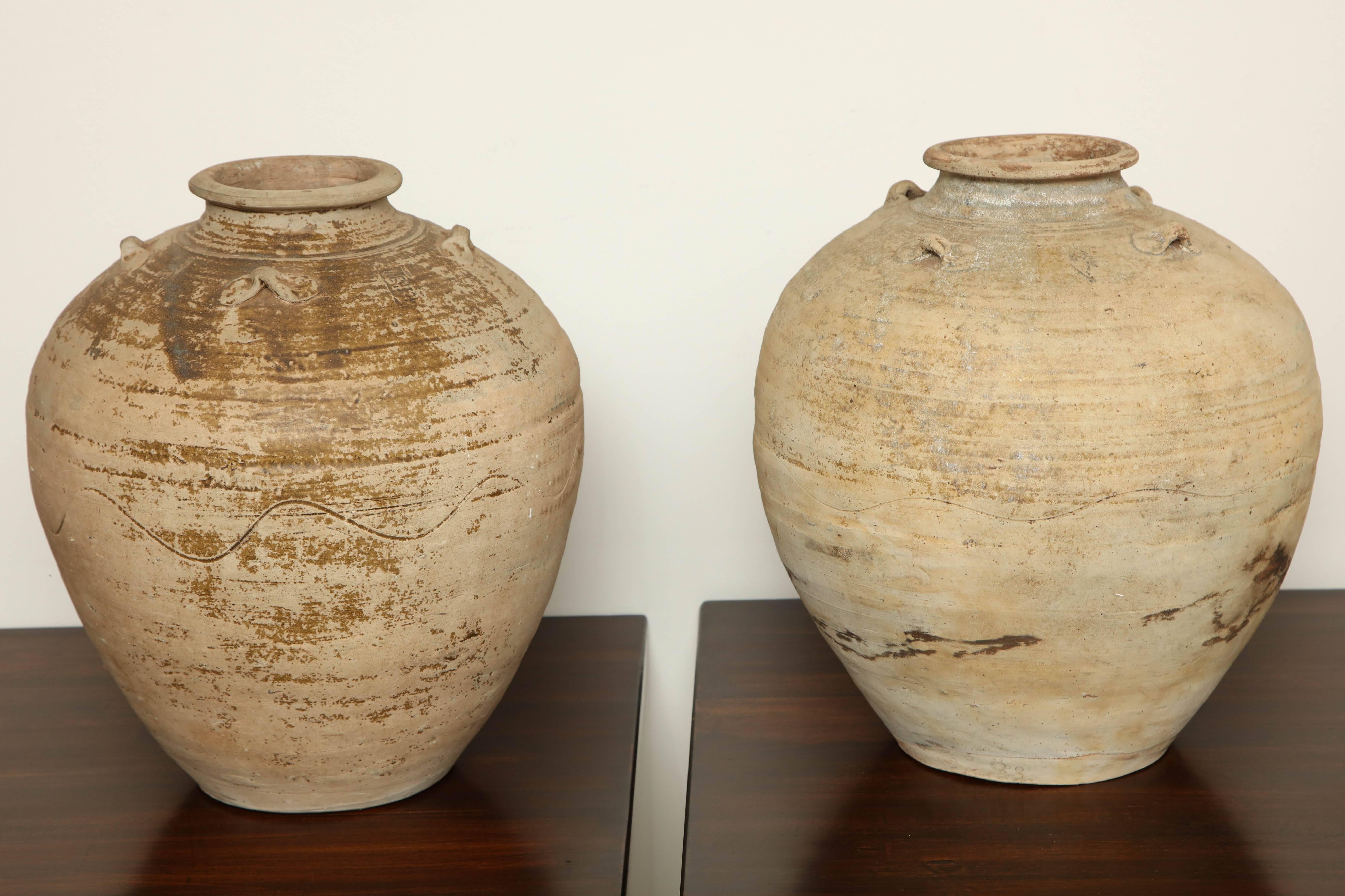 A spectacular pair of early 20th century terracotta vases, made in Indonesia.