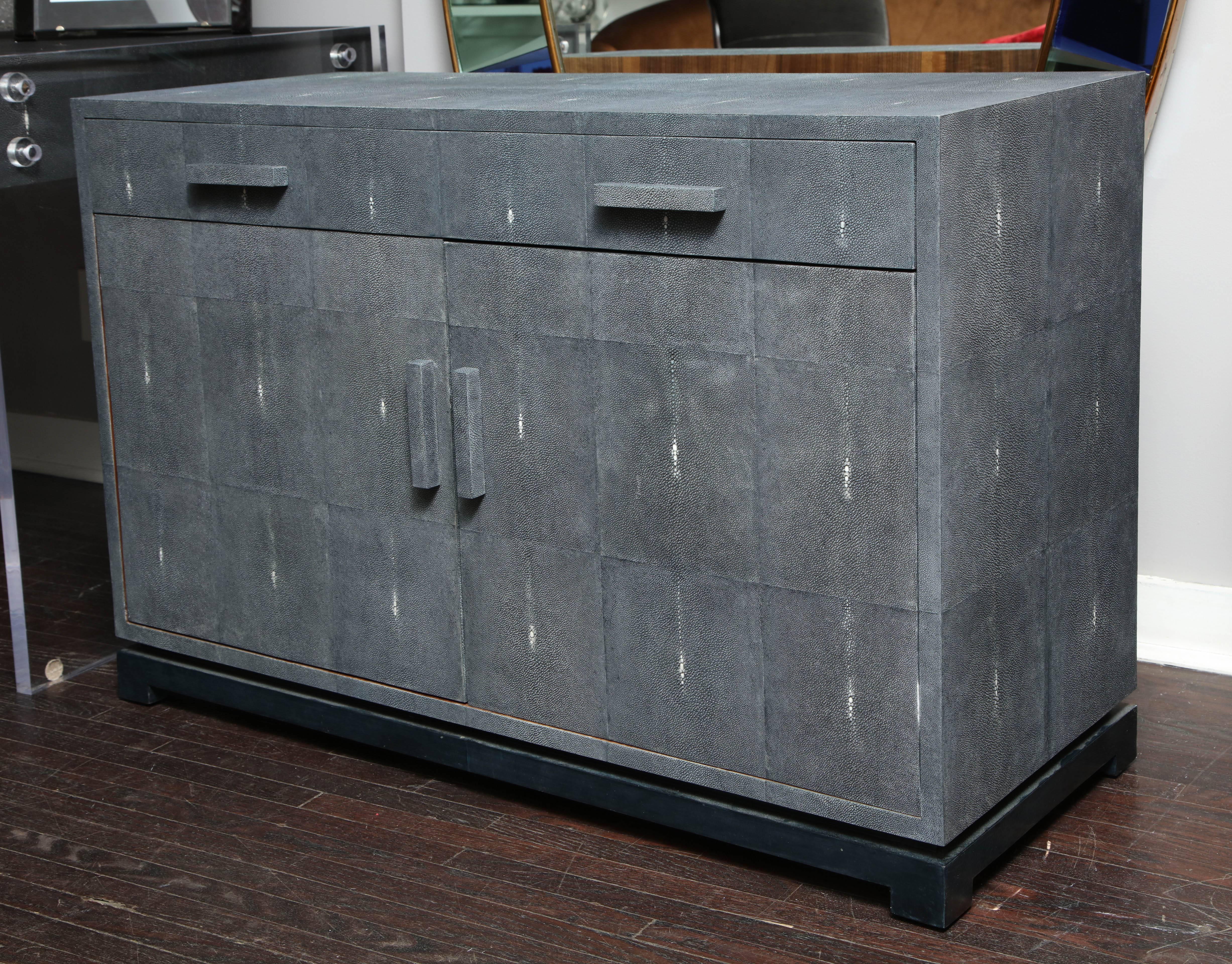 This is a floor model shagreen sideboard available for immediate purchase. The piece was handmade with genuine shagreen dyed in gray color. Each shagreen skin shows slight tone variations of gray and spine dots that are only unique to genuine