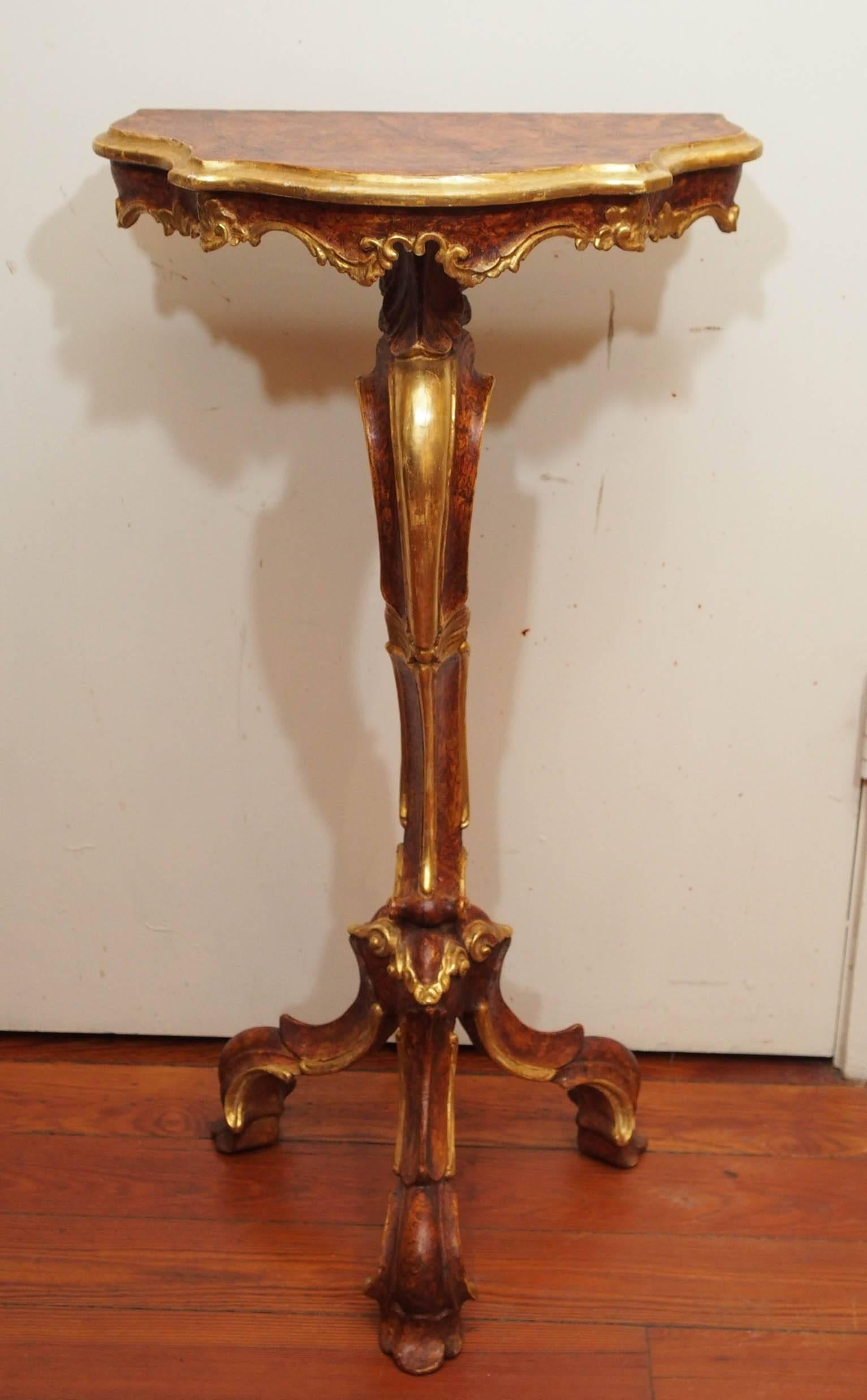 Pair of painted and parcel-gilt Italian Louis XV sellette. Single trunk on trifed base and triangle shaped top. Painted finish with gilt edges and accents.