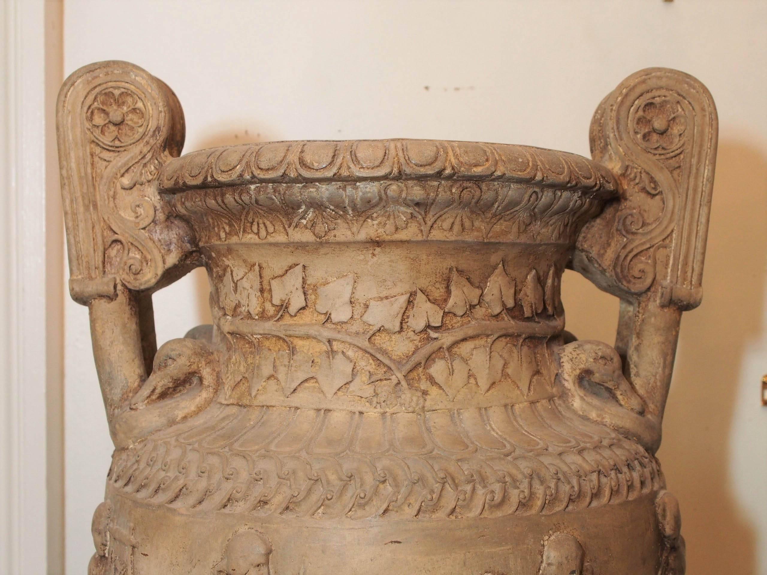 Pair of monumental white terra cotta classical form urns.
 