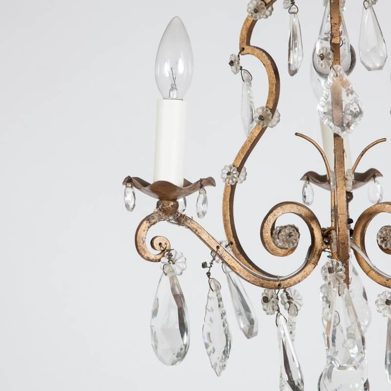 A three-arm cage chandelier with crystal drops.