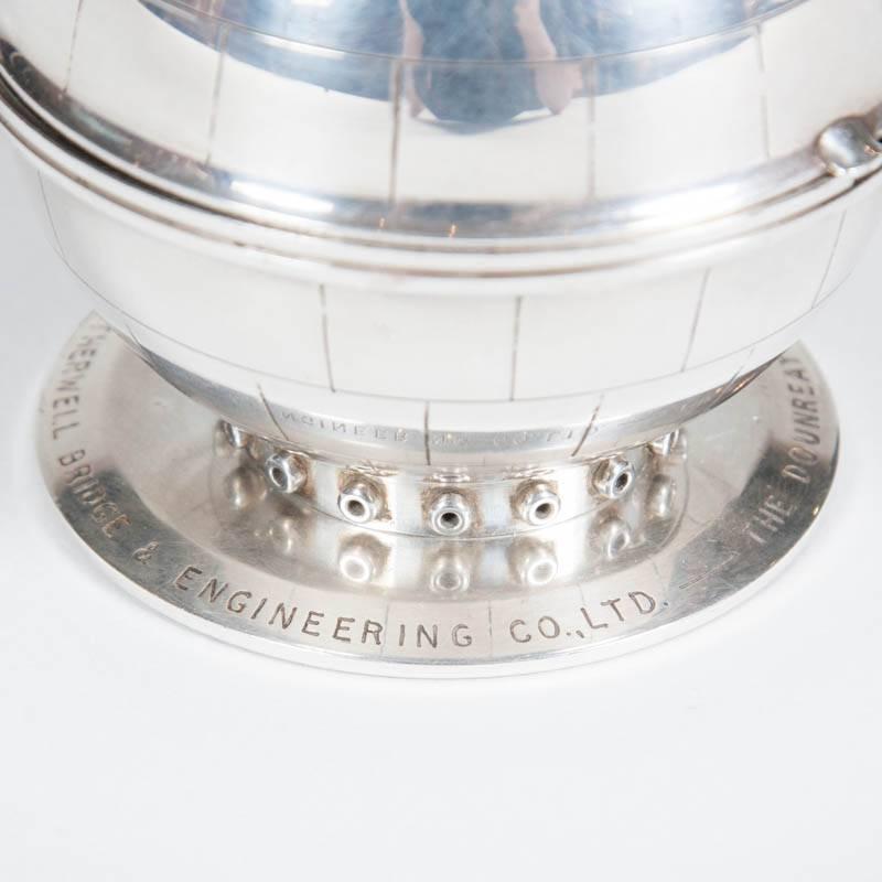 A table lighter depicting the Dounreay Reactor Sphere, dated 1956.

Removable petrol lighter by Ronson.

The base reads: THE DOUNREAY REACTOR SPHERE. 1956 - THE MOTHERWELL BRIDGE & ENGINEERING CO. LTD.

The Dounreay fast reactor:

The