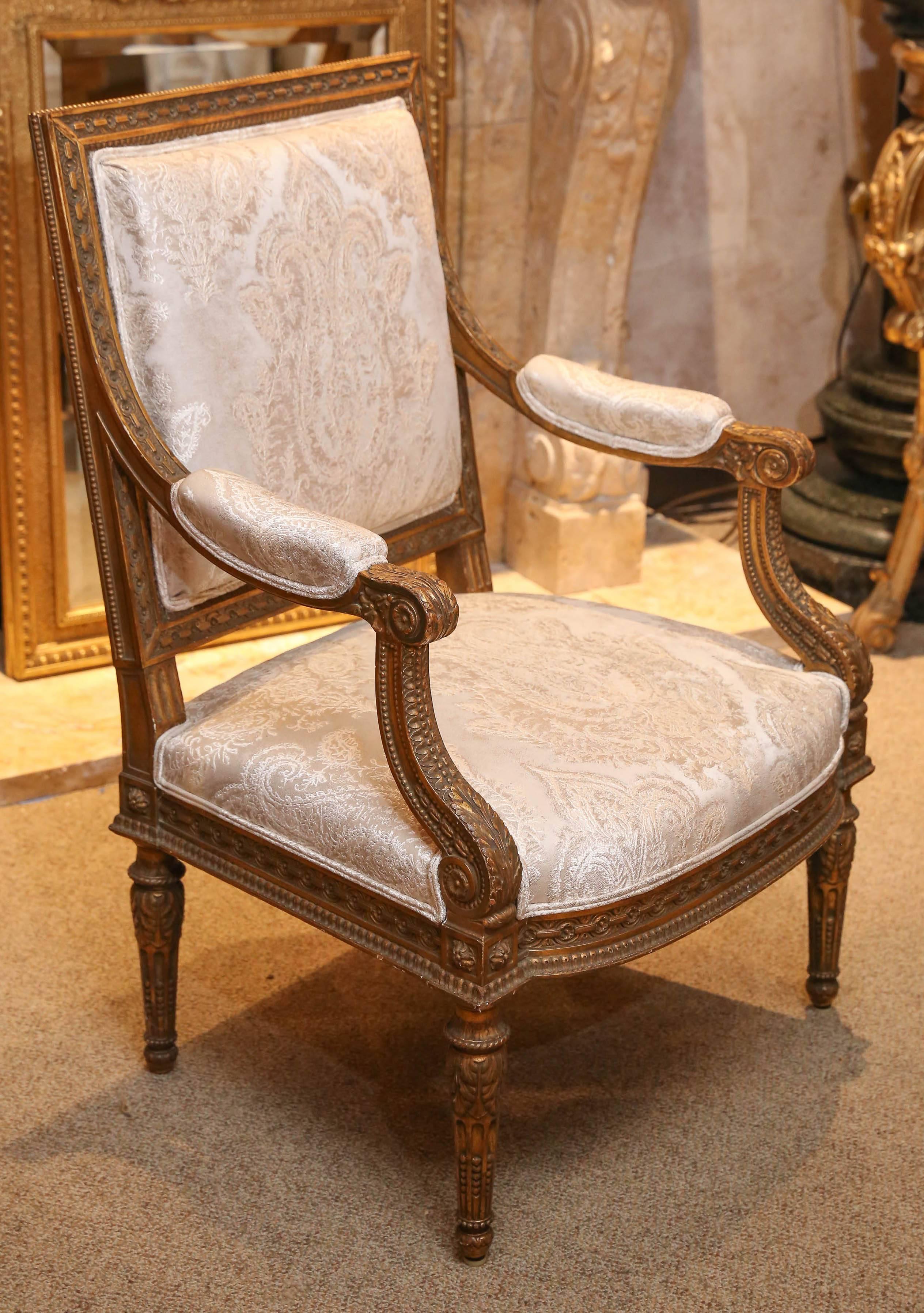 Pair of highly carved armchairs with intricate and superb designs, padded arms
Square shaped back, giltwood rising on tapered ribbed legs.