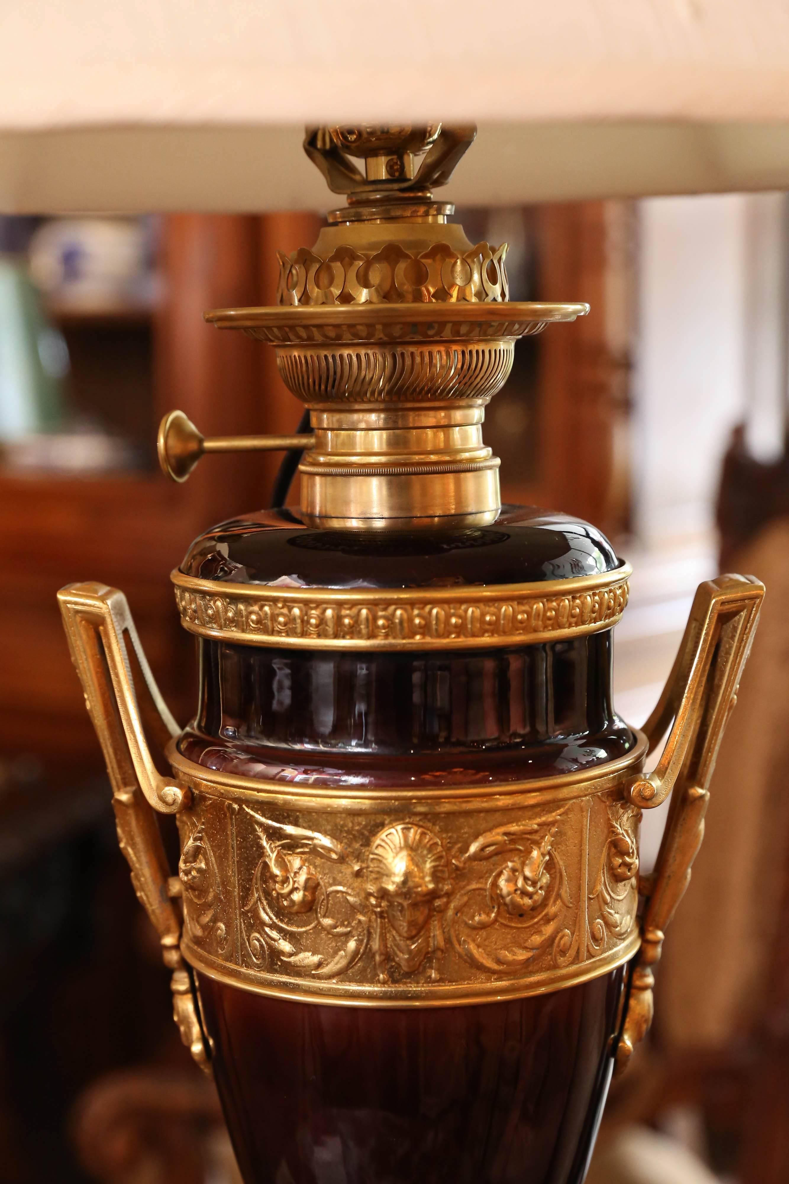 Bronze colored porcelain with gilt porcelain mounts set on a square base of
Gilt bronze. The urn form is banded in bronze doré with scrolls and
Centered with a mask. Decorative handles are on each side.
They are by Hugo Schneider in Lipzeig