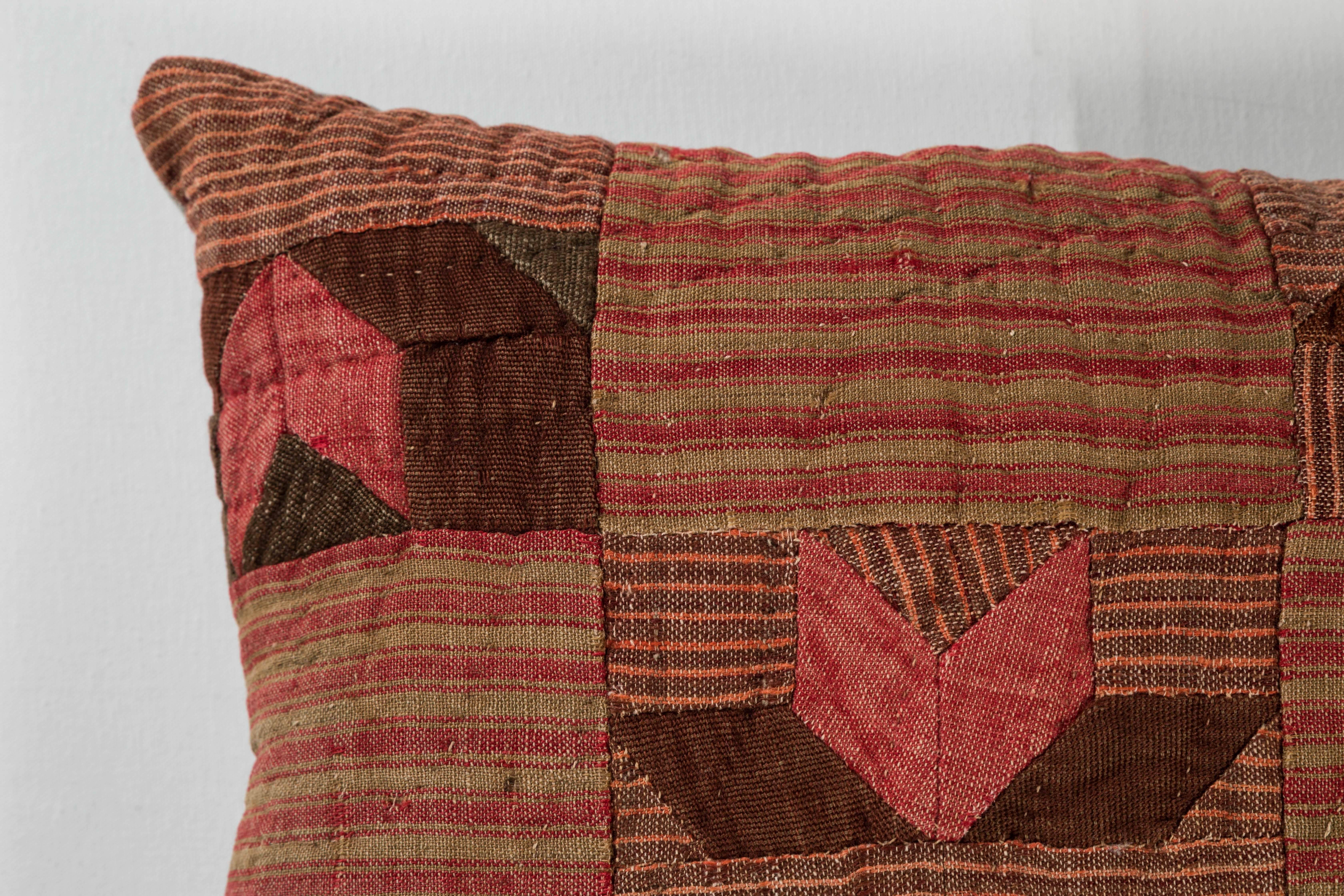 Patchwork of handwoven pieces of 19th century French linen. Natural dye colors: rust red, olive green and brown. Natural color linen back, feather and down fill and invisible zipper.