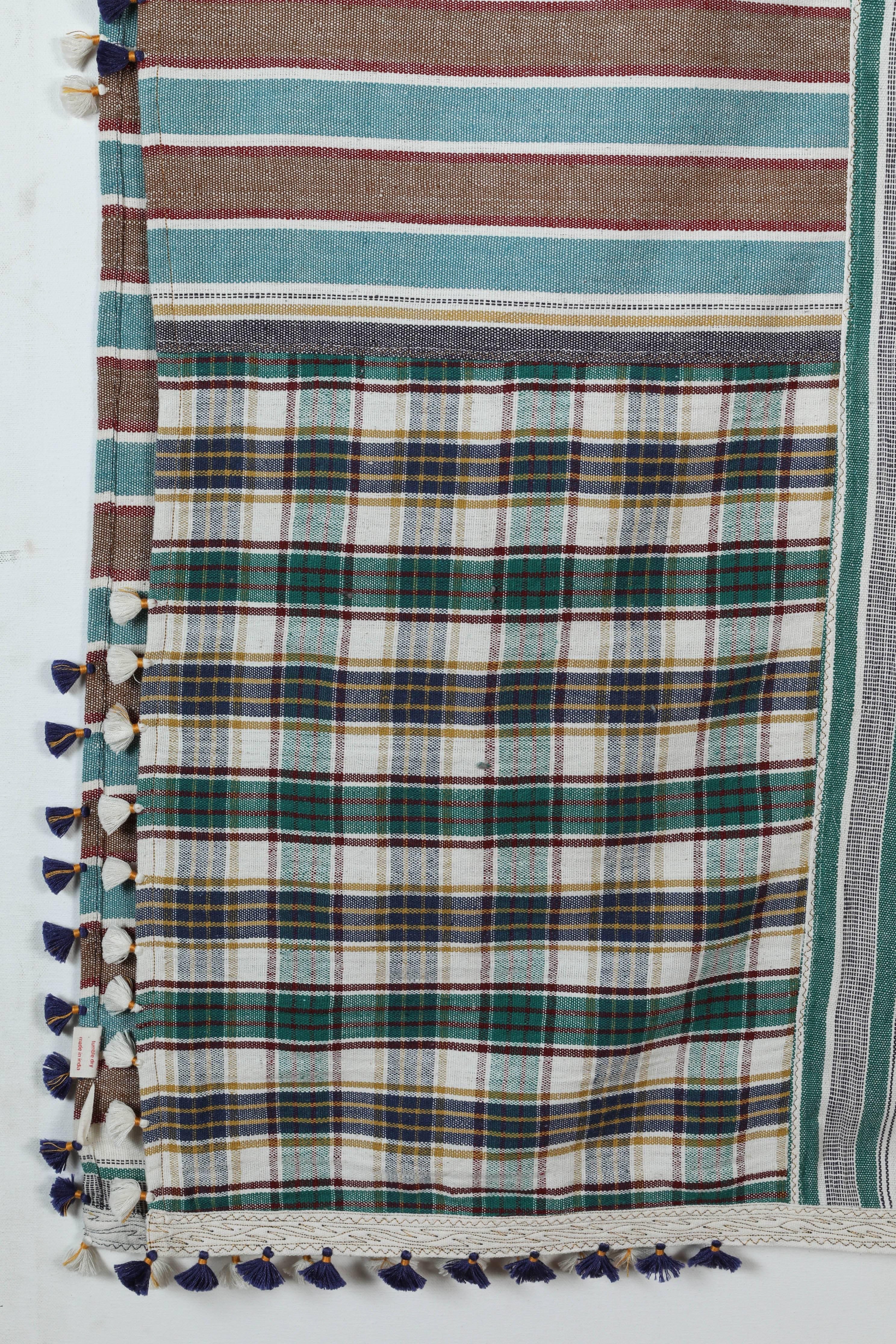 Kala naturally dyed organic cotton from Gujarat, India. Hand-loomed using traditional Indian textile techniques to produce extra weft woven stripes and plaids. This green, turquoise blue, brown and ivory bedcover has added hand-knotted tassels.