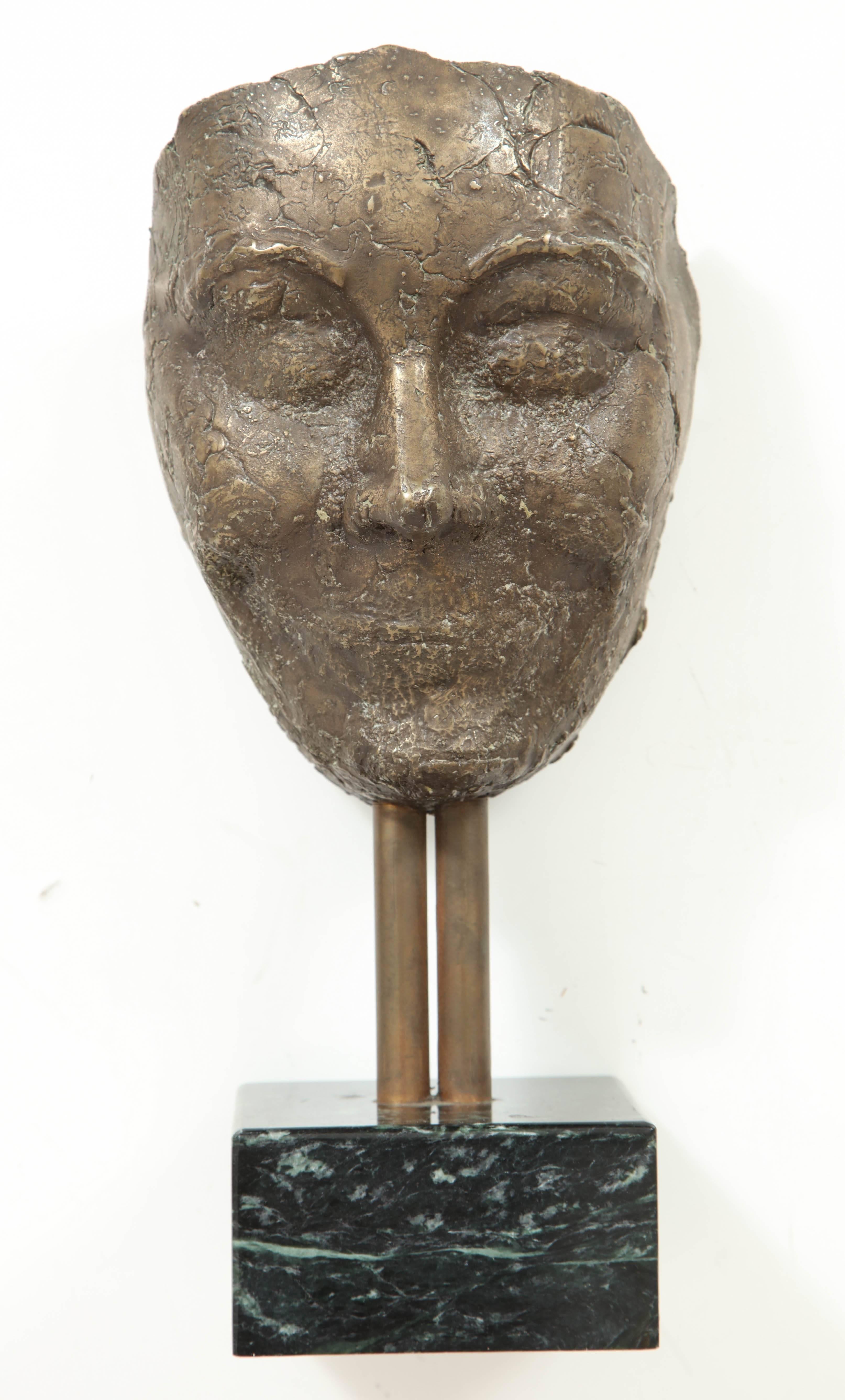Bronze mask on marble plinth, unsigned.