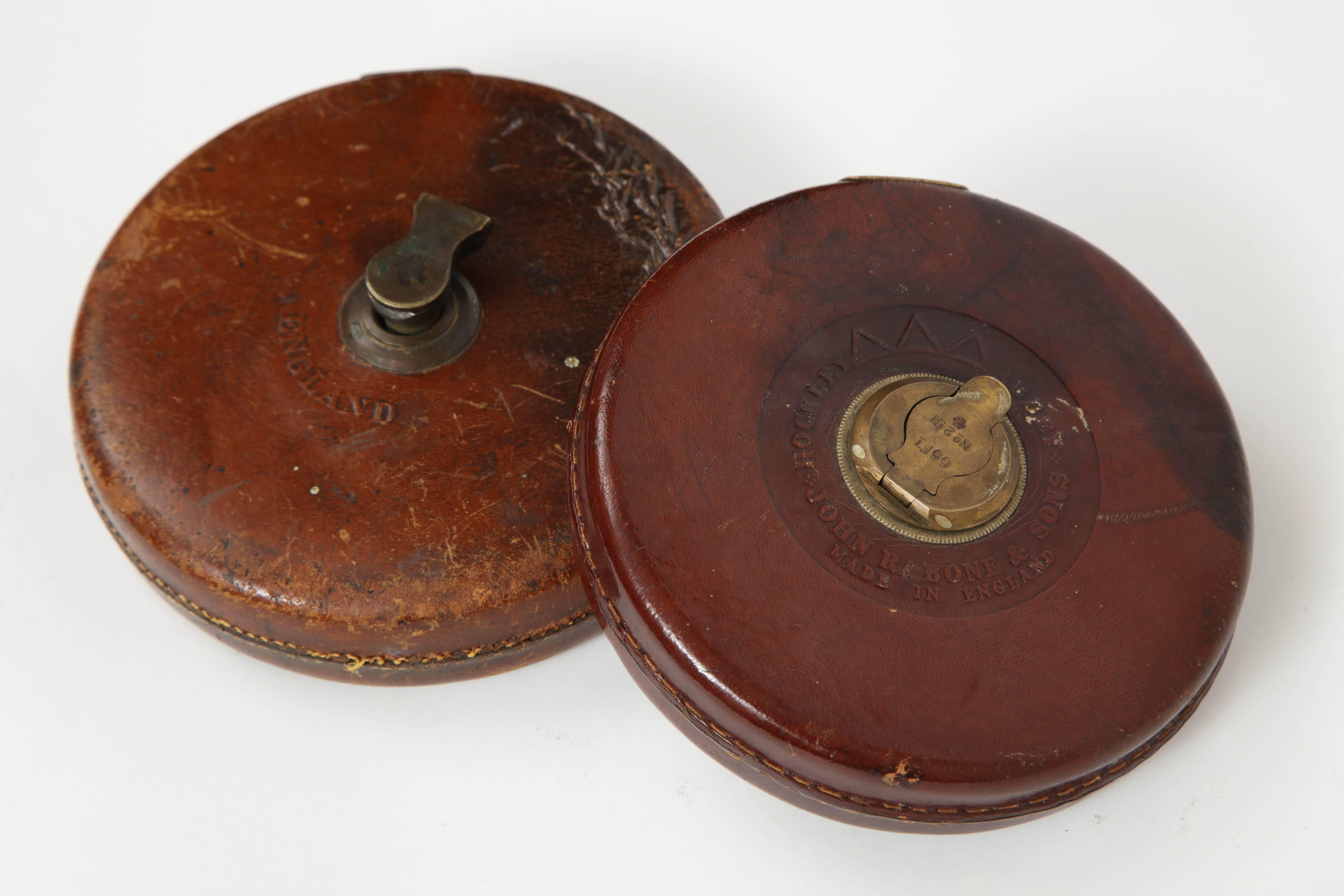 Vintage leather and brass tape measure. Measures: 66 ft.