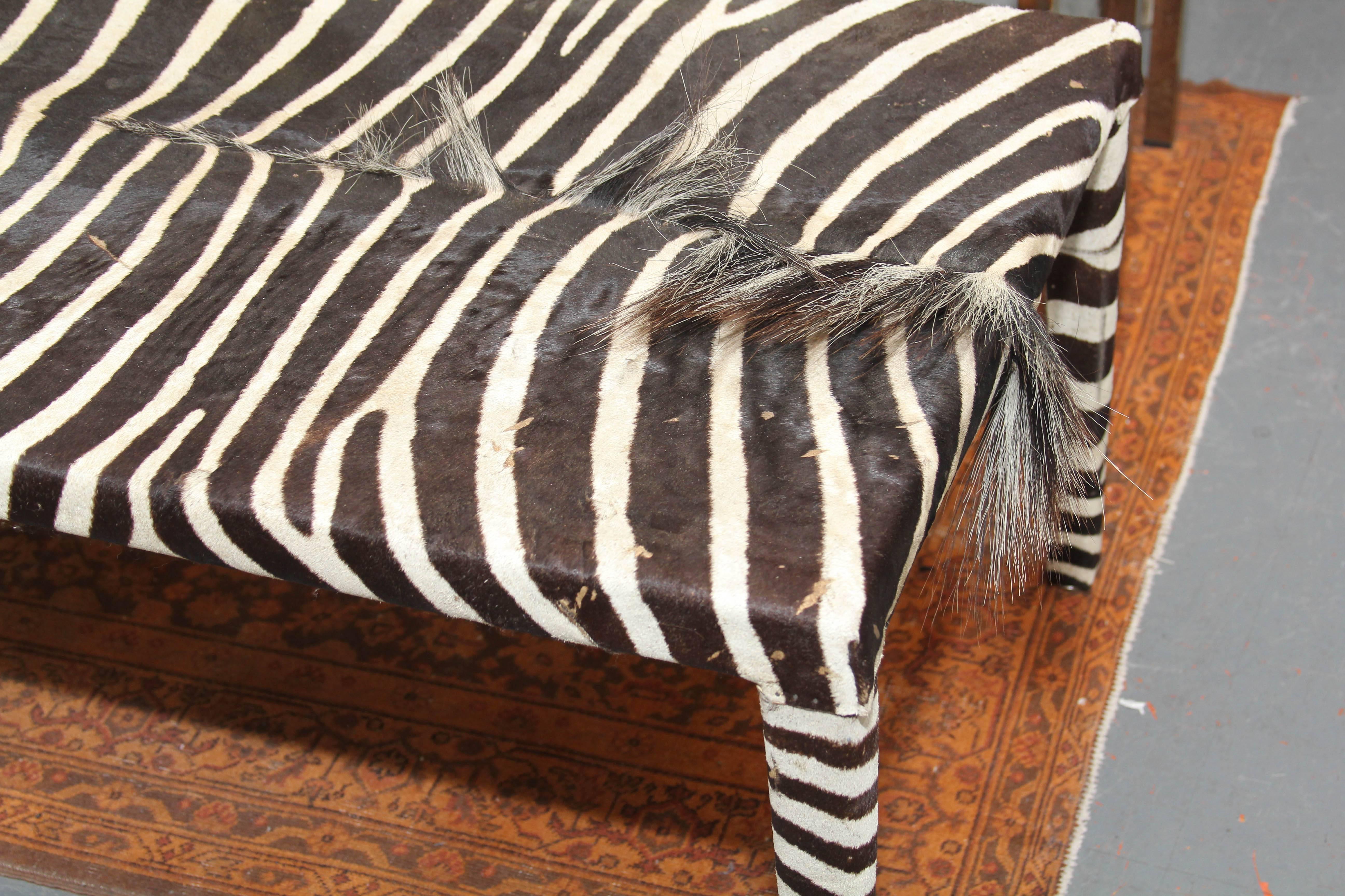 Striking black and white zebra coffee table or bench. Generous length shows of the beauty of the hide and works well as table or at the foot of a bed.