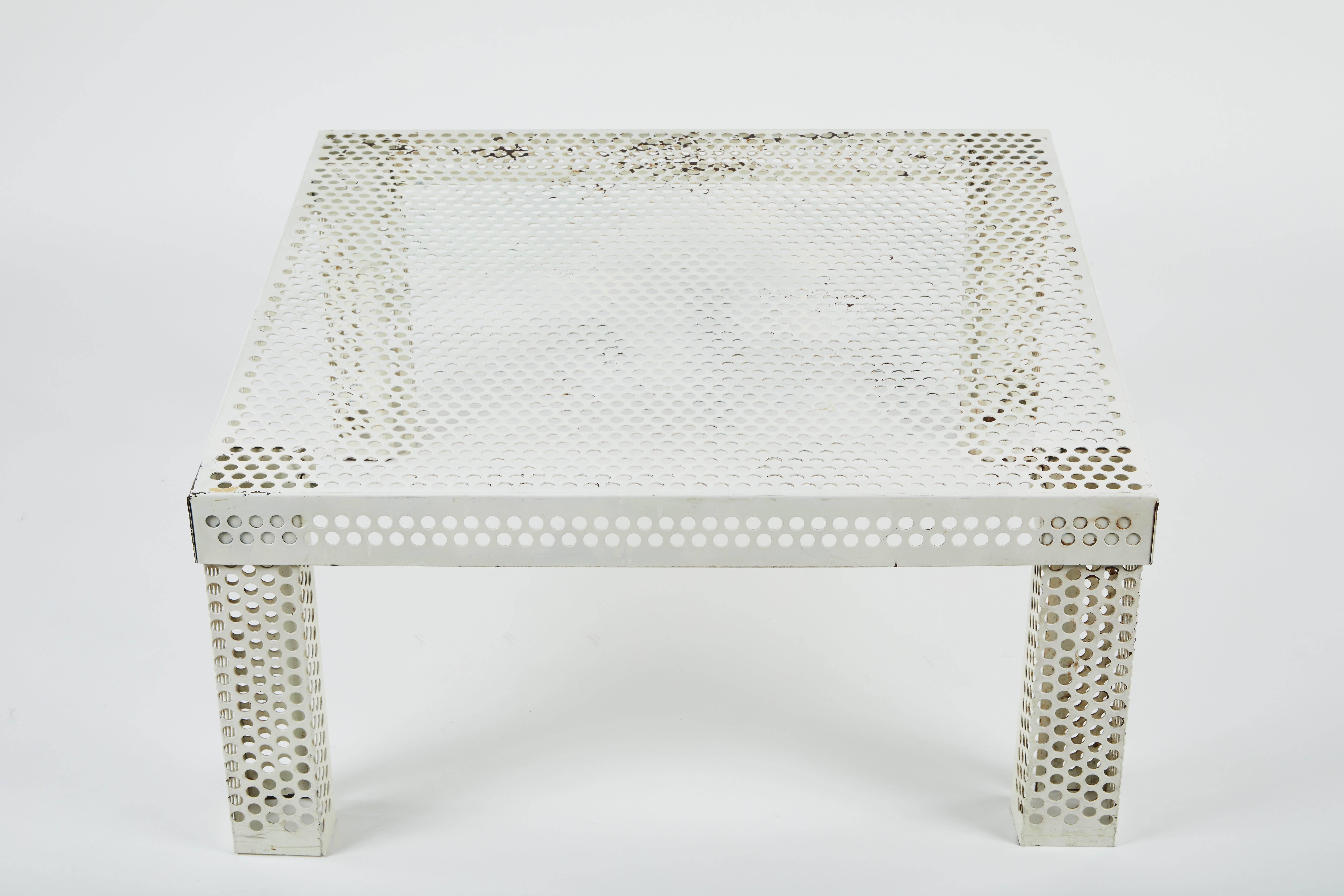 Perforated white lacquered metal coffee table in the style of Mathieu Matégot, circa 1950s. Original condition showing wear consistent with age and use.